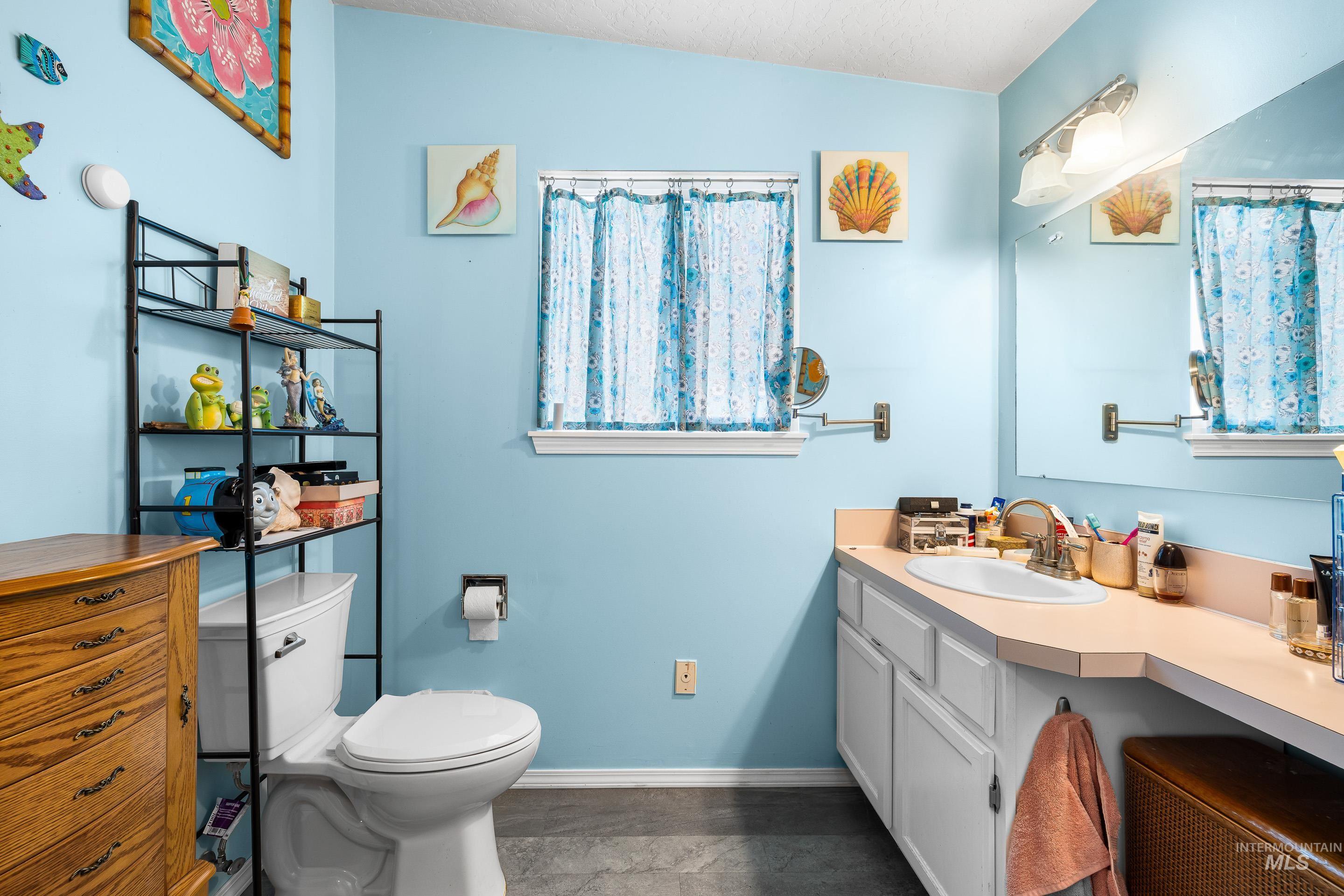 Bathroom with vanity and a textured ceiling