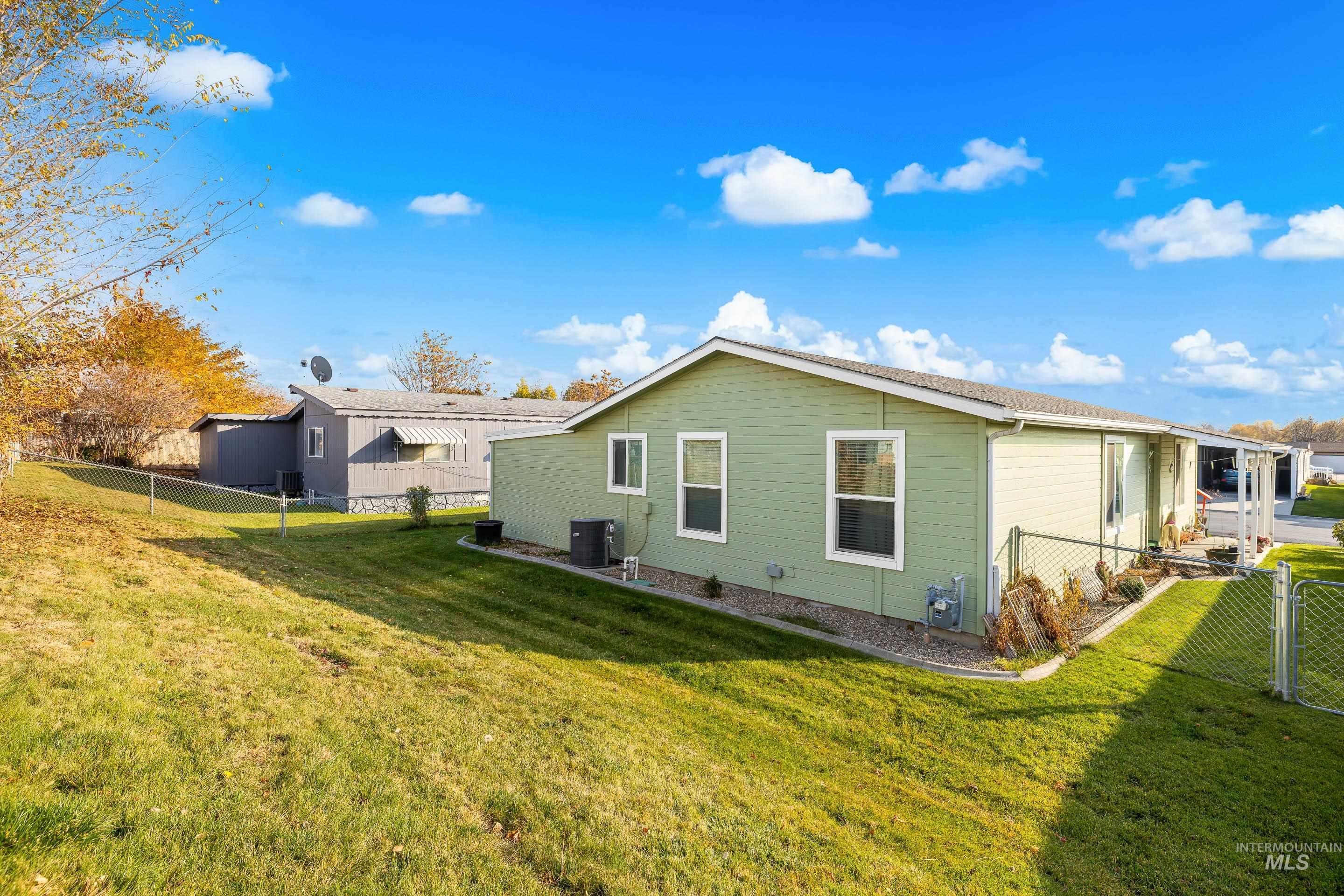 Rear view of property with a fenced backyard