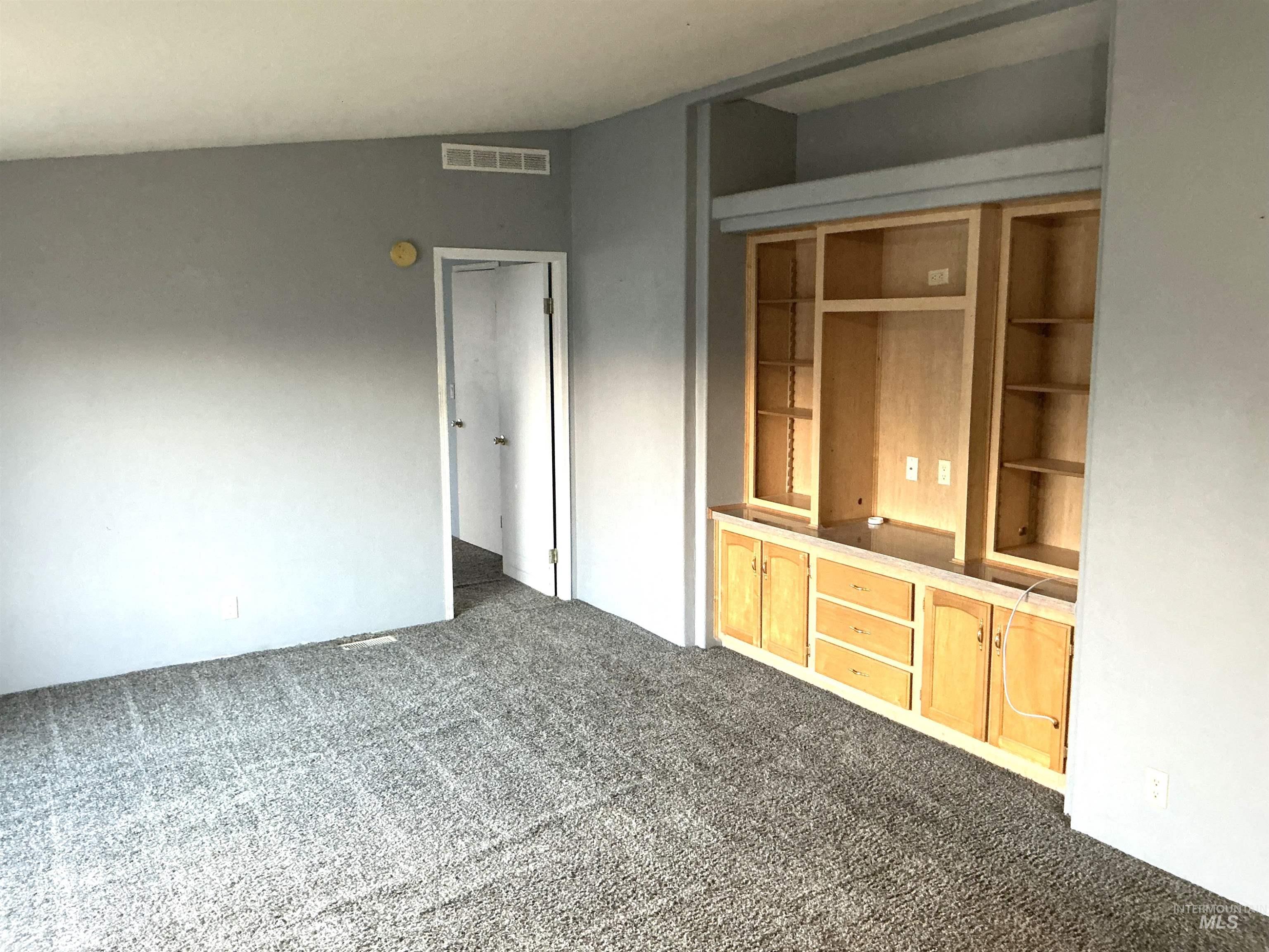 Unfurnished living room with dark colored carpet