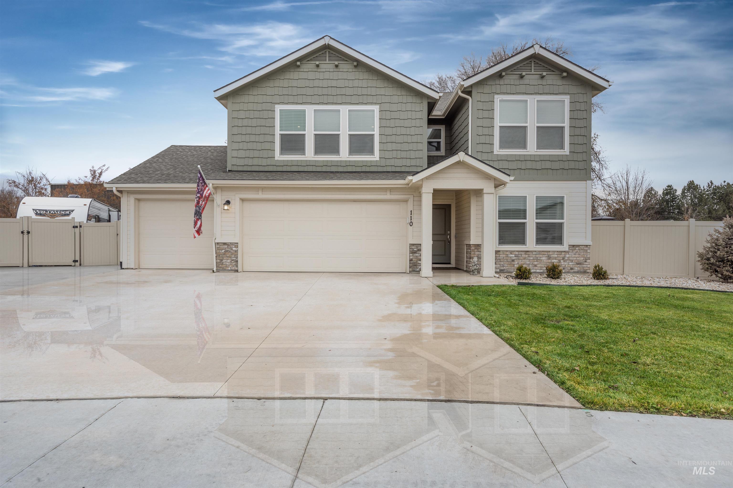 Craftsman house with concrete driveway, stone siding, and a gate