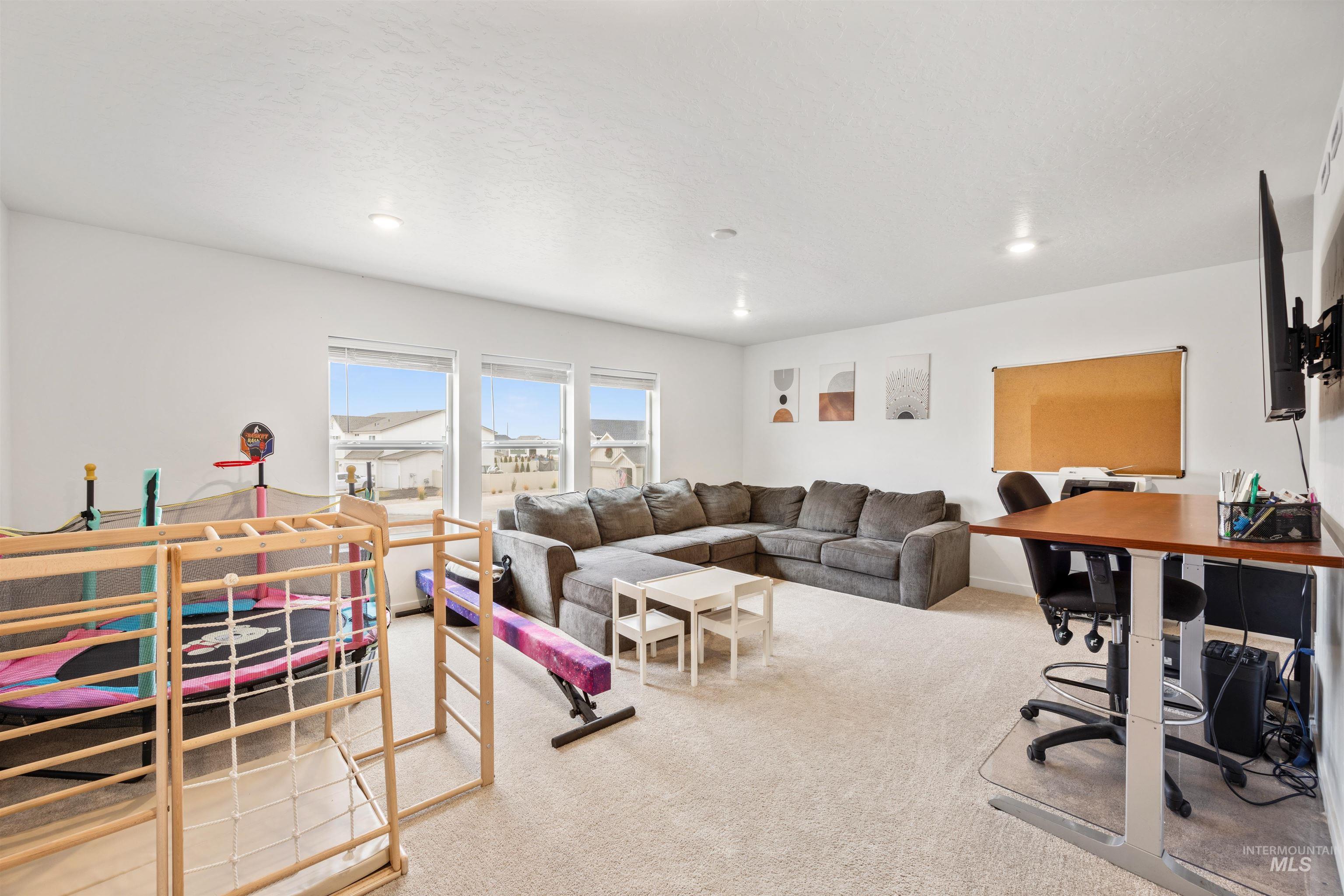 Living area featuring an office area, light colored carpet, and recessed lighting