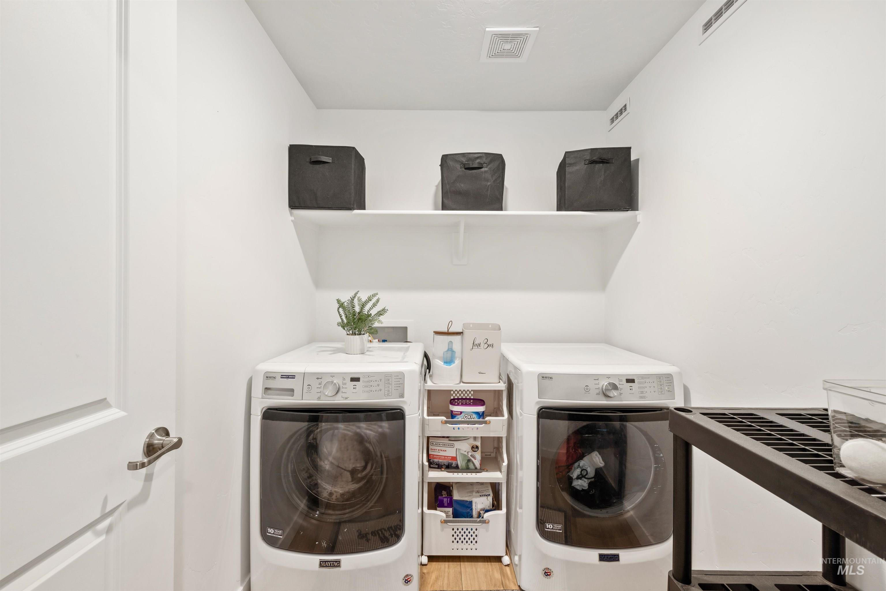 Laundry room featuring washing machine and clothes dryer
