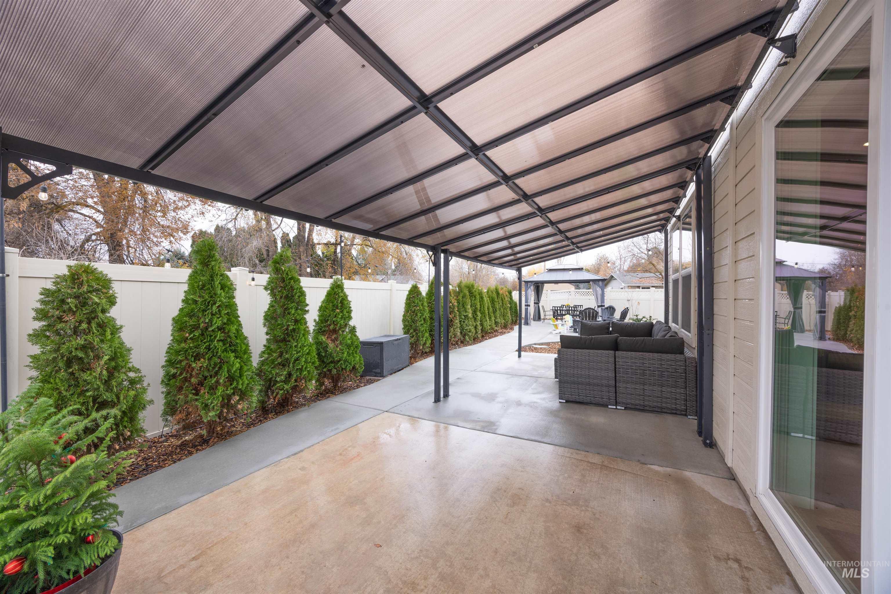 Fenced backyard with a patio area and outdoor lounge area