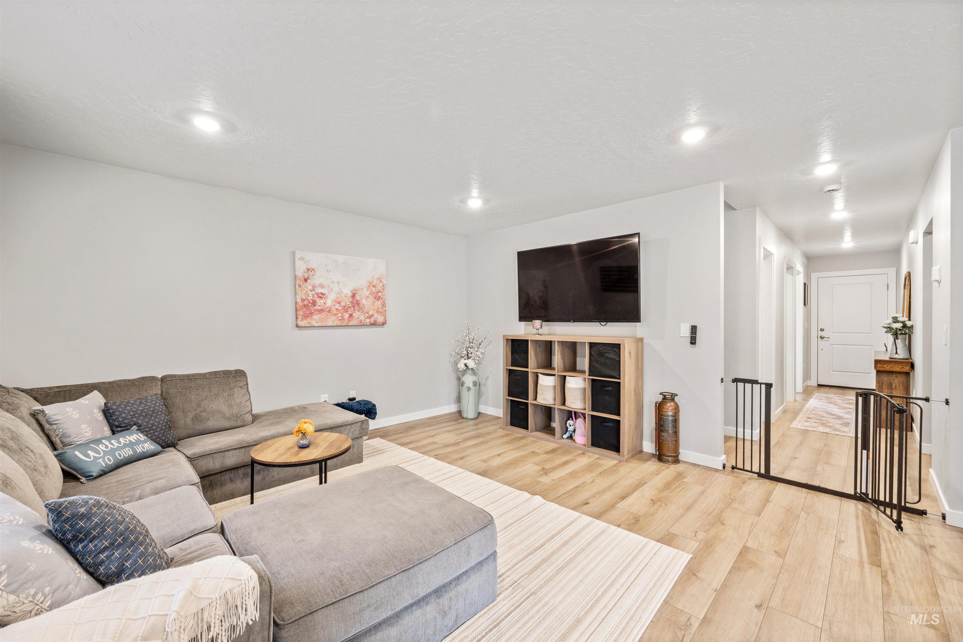 Living room with wood finished floors and recessed lighting
