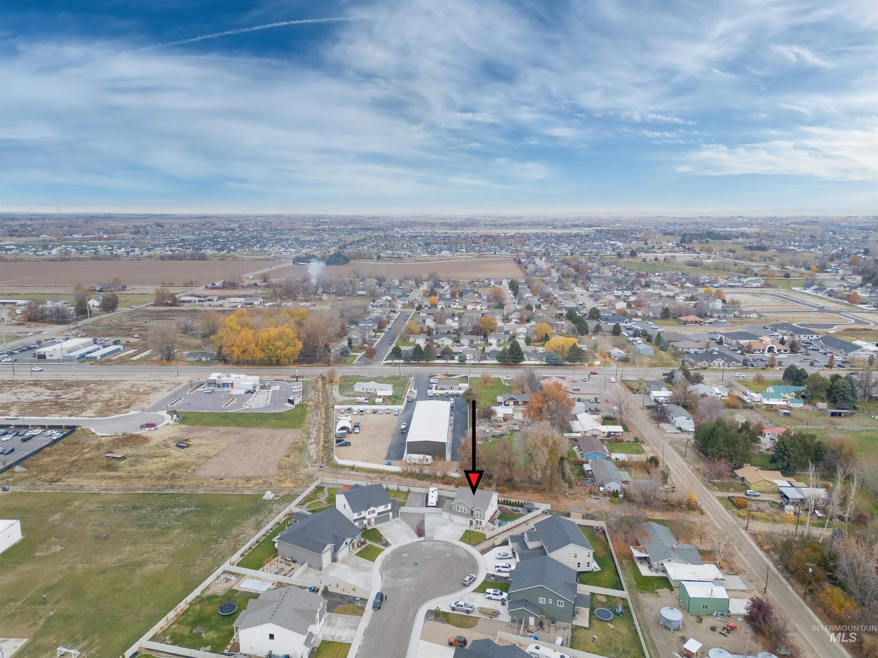 Aerial view of property's location featuring nearby suburban area