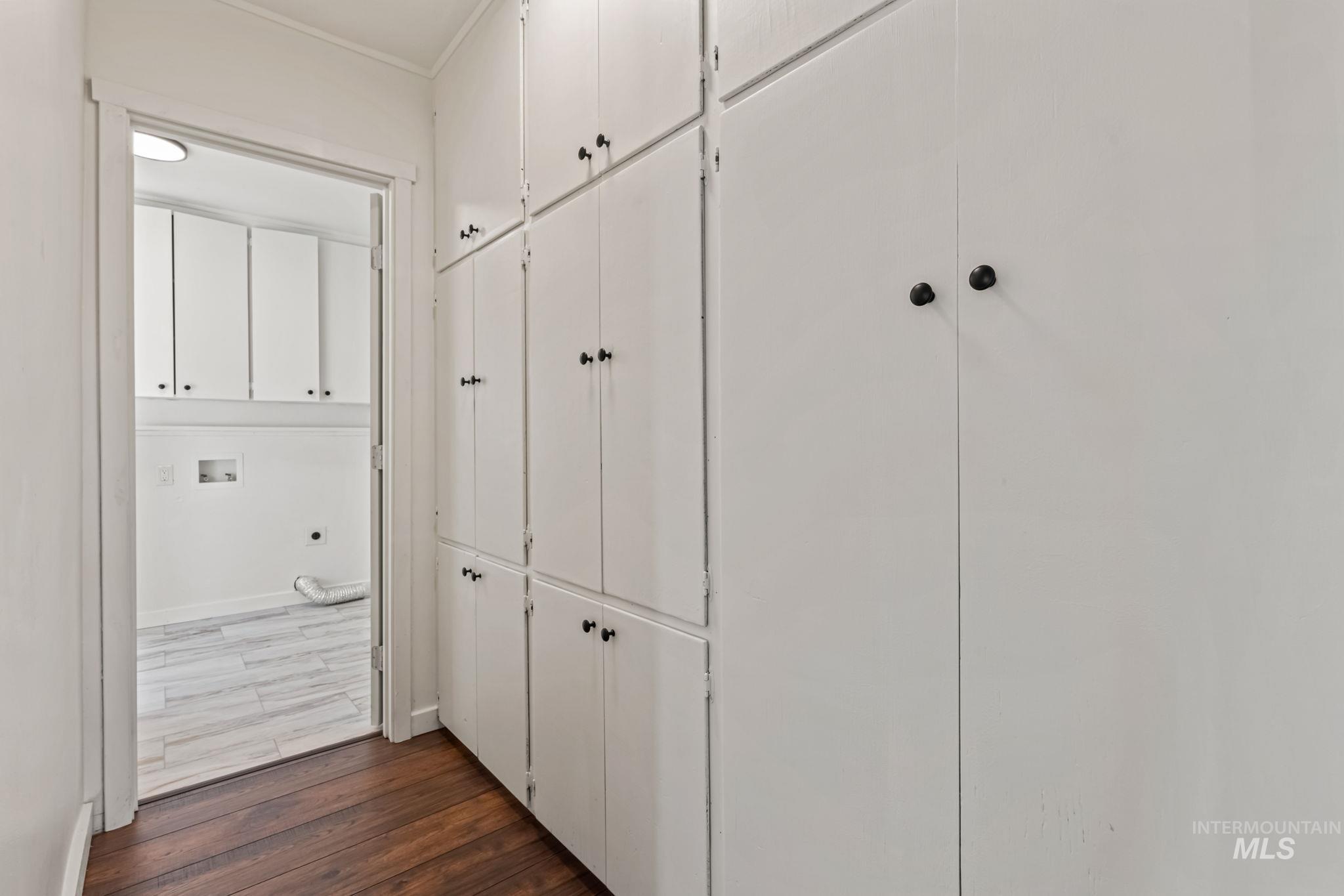 Hall featuring dark wood-style floors