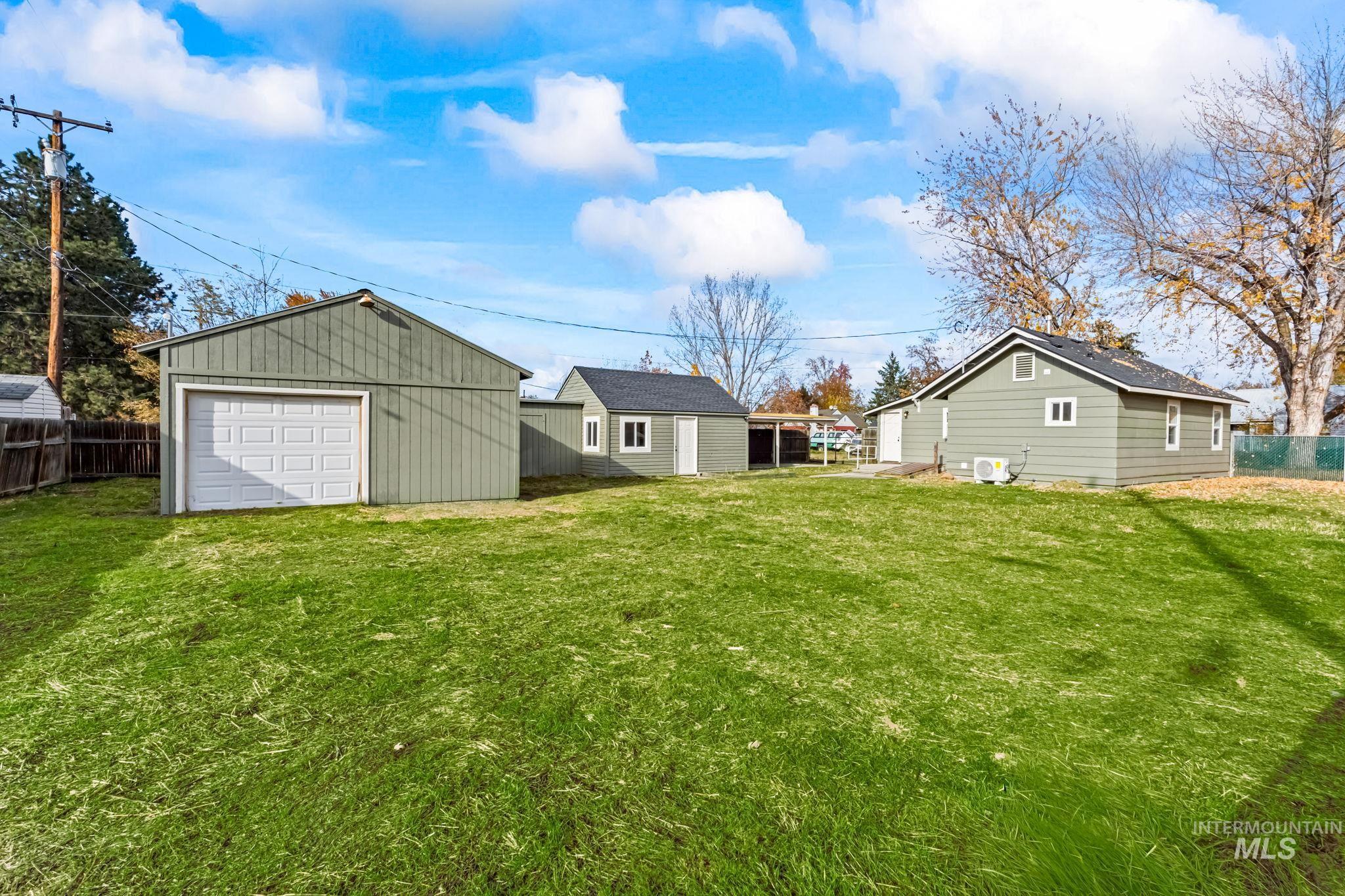 View of yard featuring an outbuilding and a detached garage