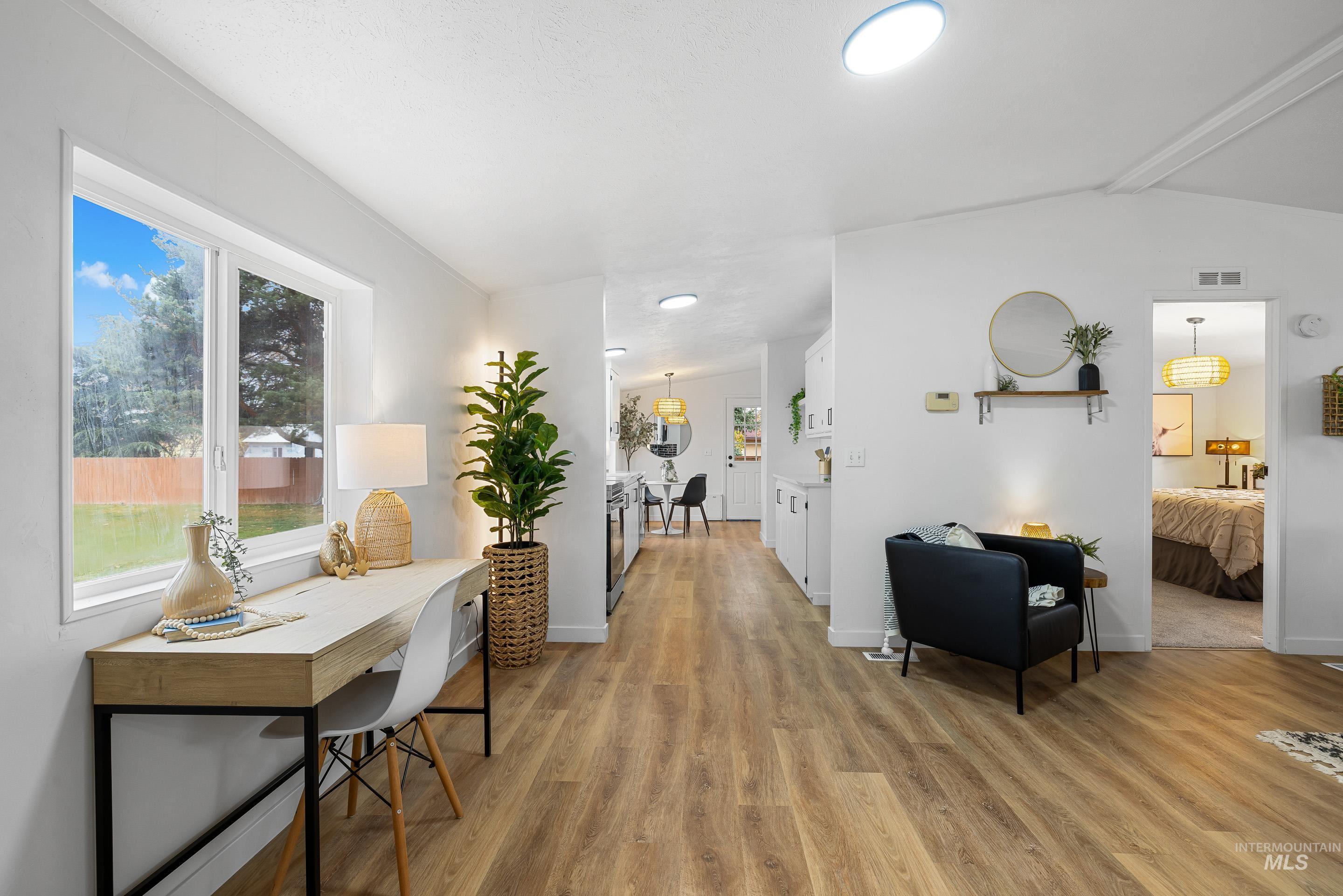 Corridor with light wood-style floors and baseboards