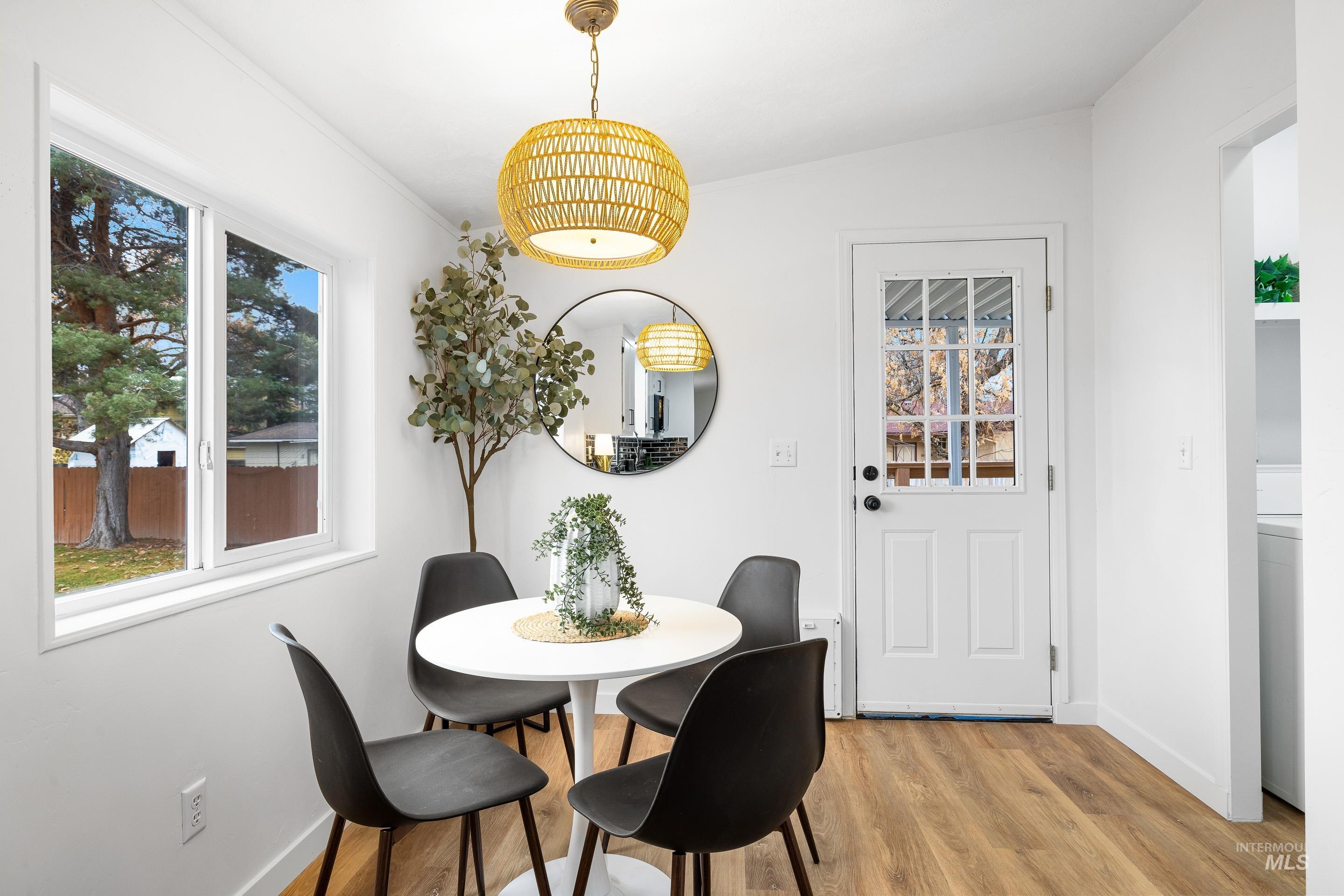 Dining area with light wood finished floors and washer / dryer