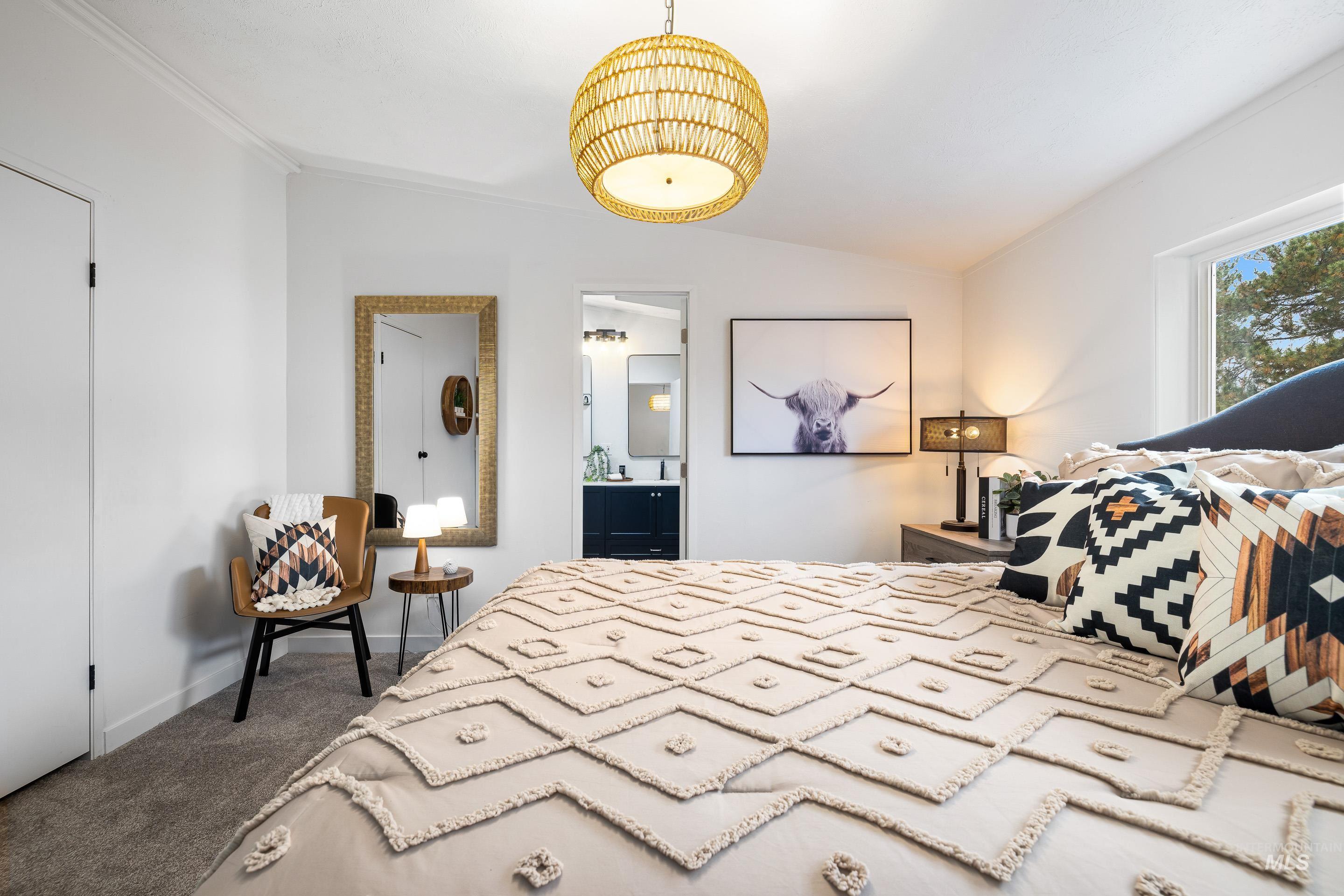 Bedroom featuring vaulted ceiling, dark colored carpet, and ensuite bathroom