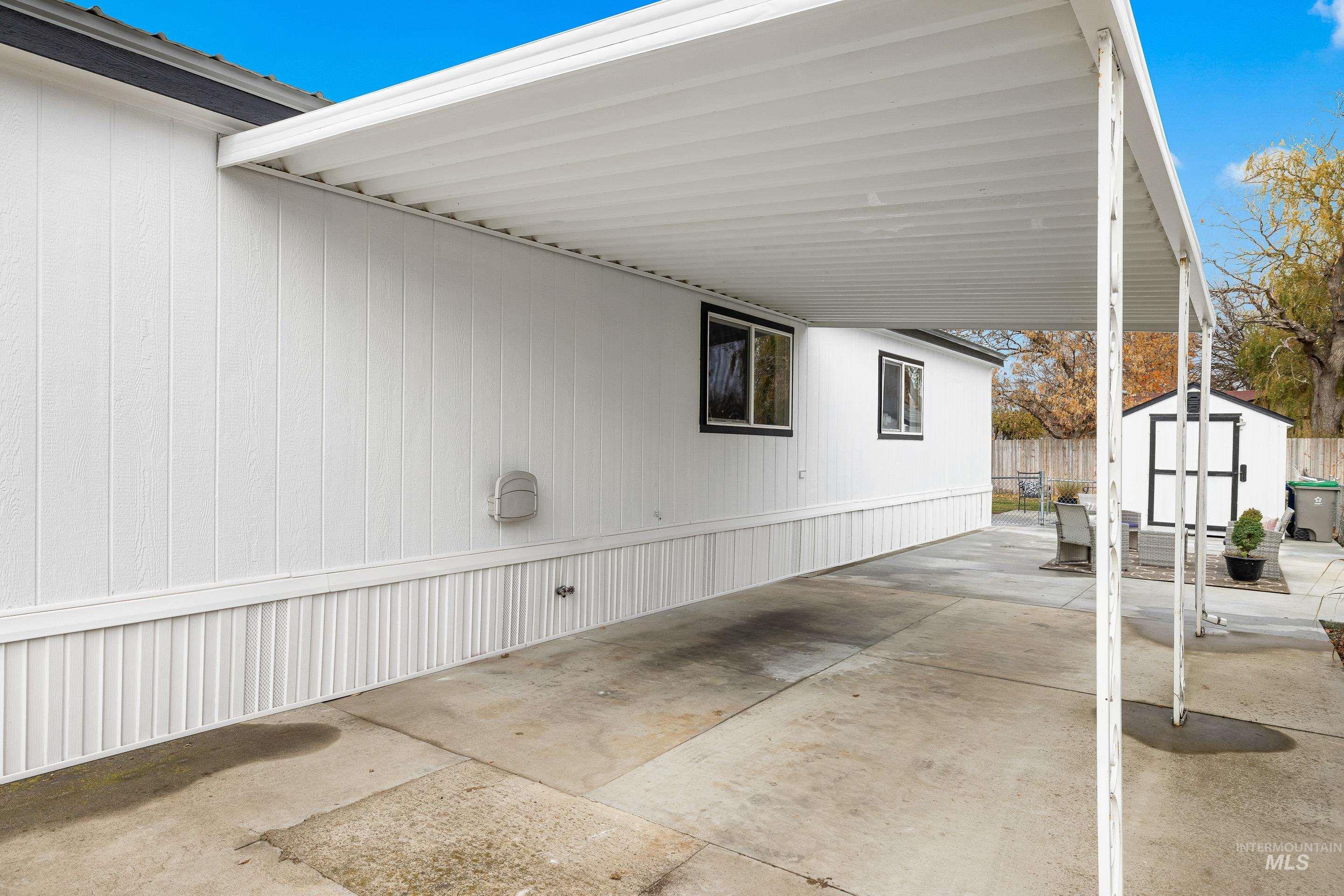 View of patio / terrace featuring a storage unit and an attached carport