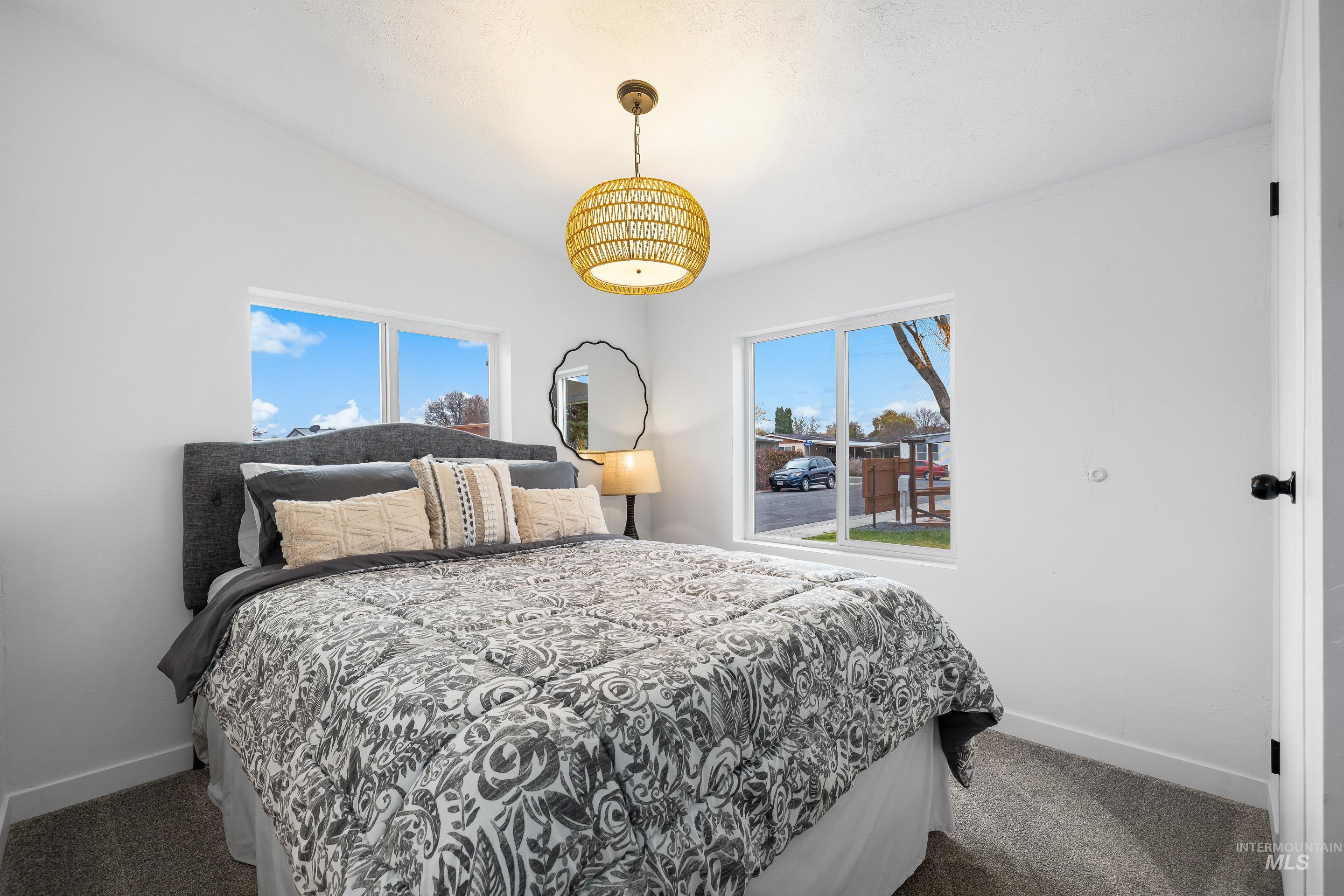 Bedroom featuring dark colored carpet