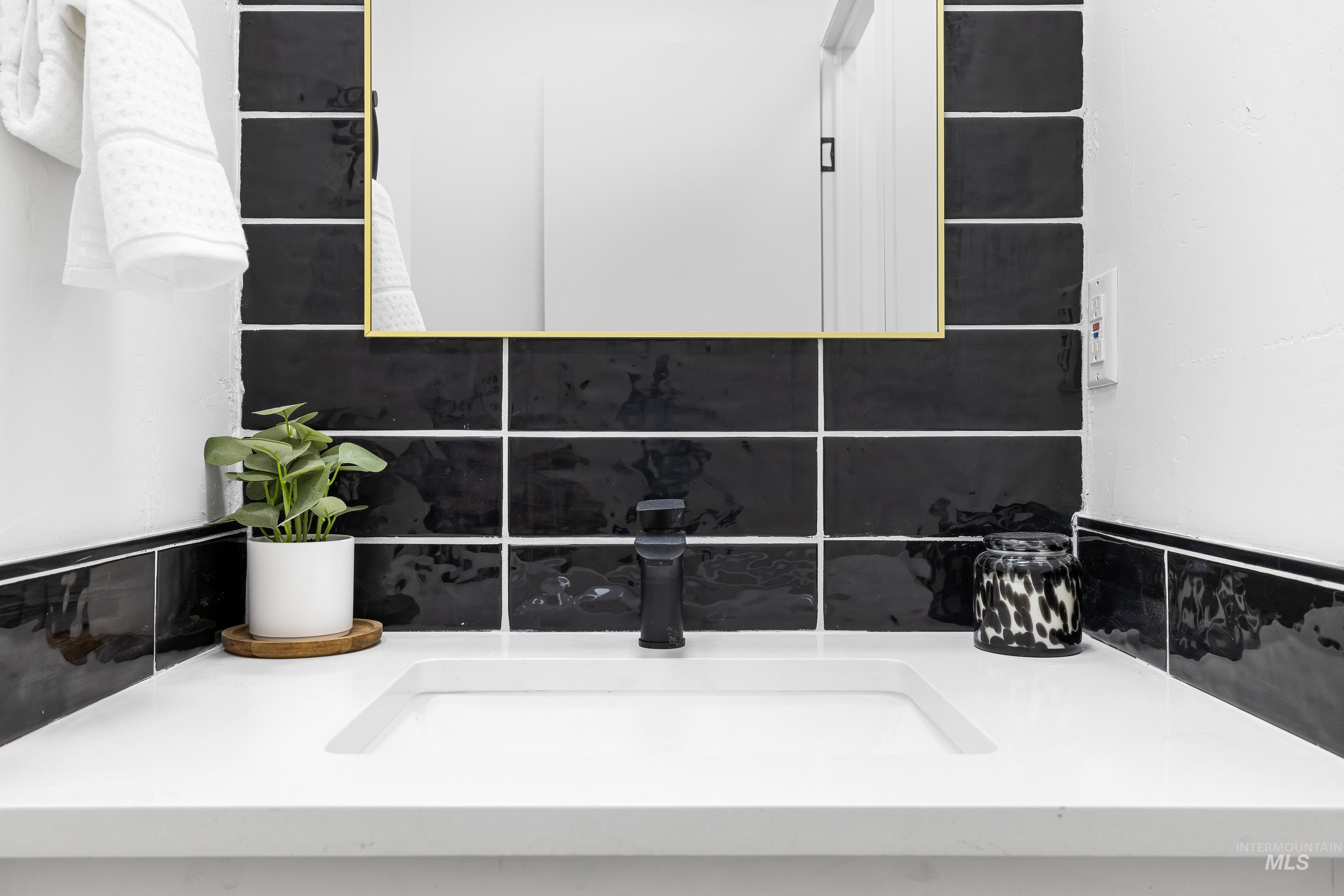 Bathroom featuring backsplash and a sink