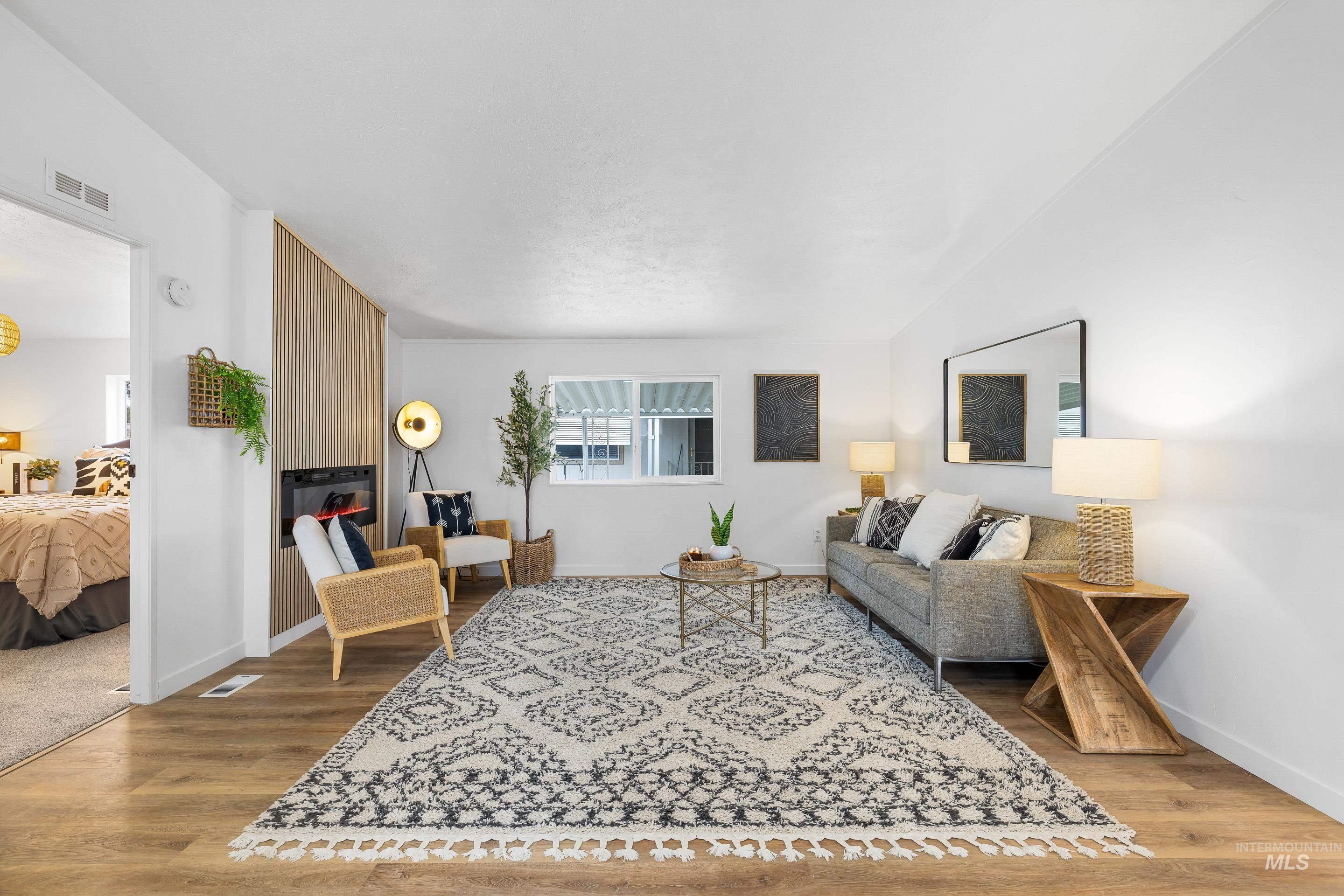 Living area with light wood-style flooring and baseboards