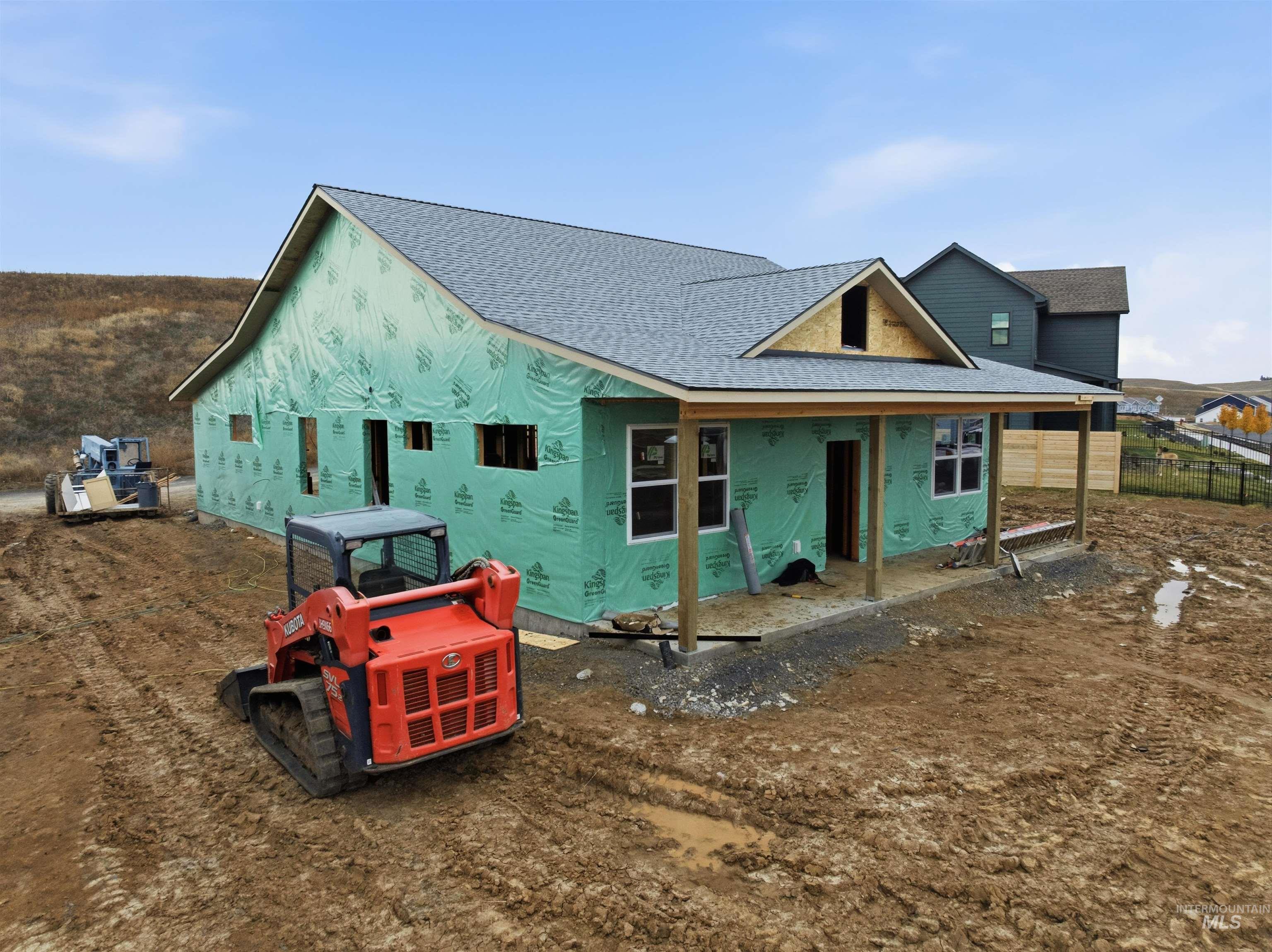 Rear view of house with a shingled roof and a porch
