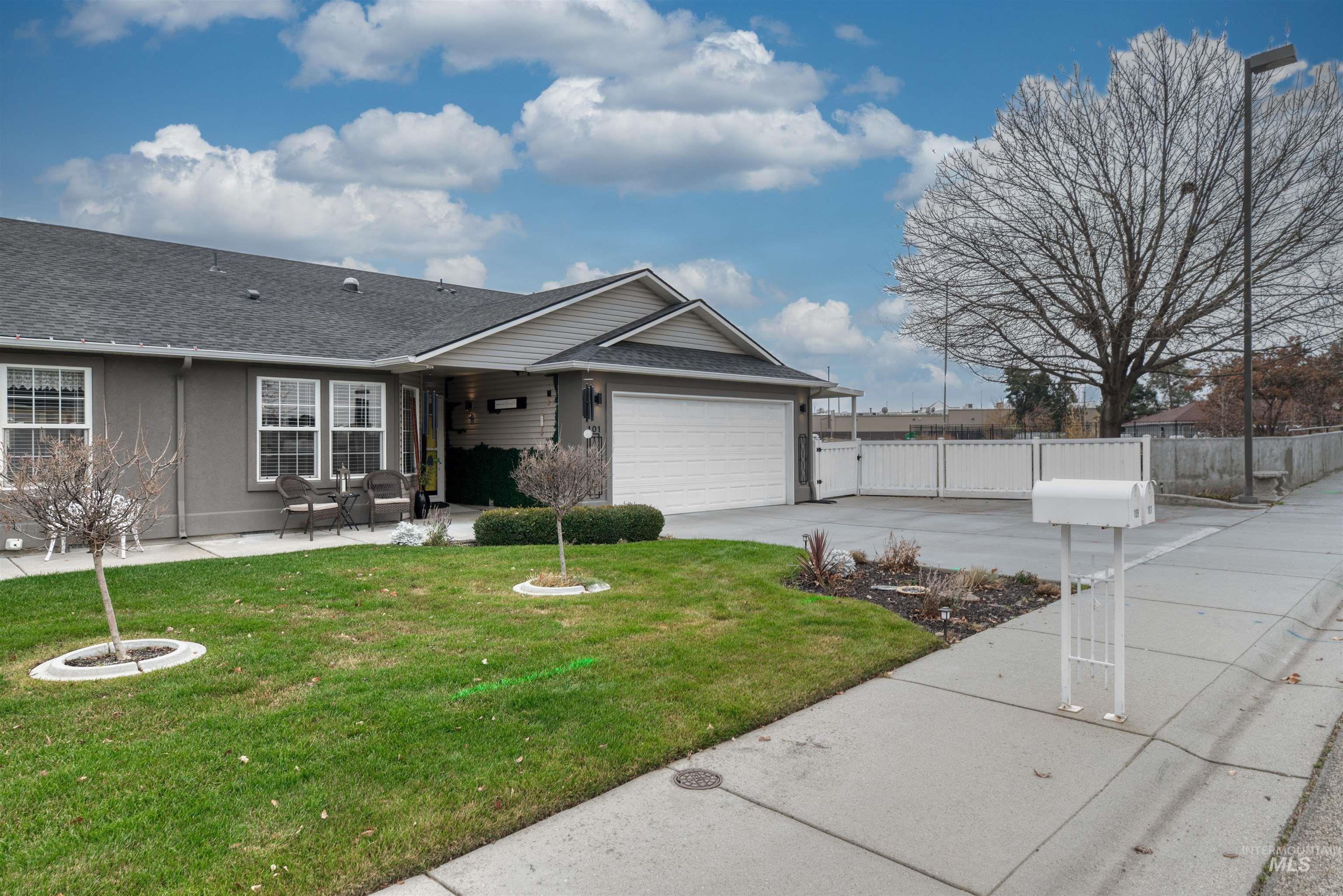 Single story home with roof with shingles, driveway, a patio area, and a garage