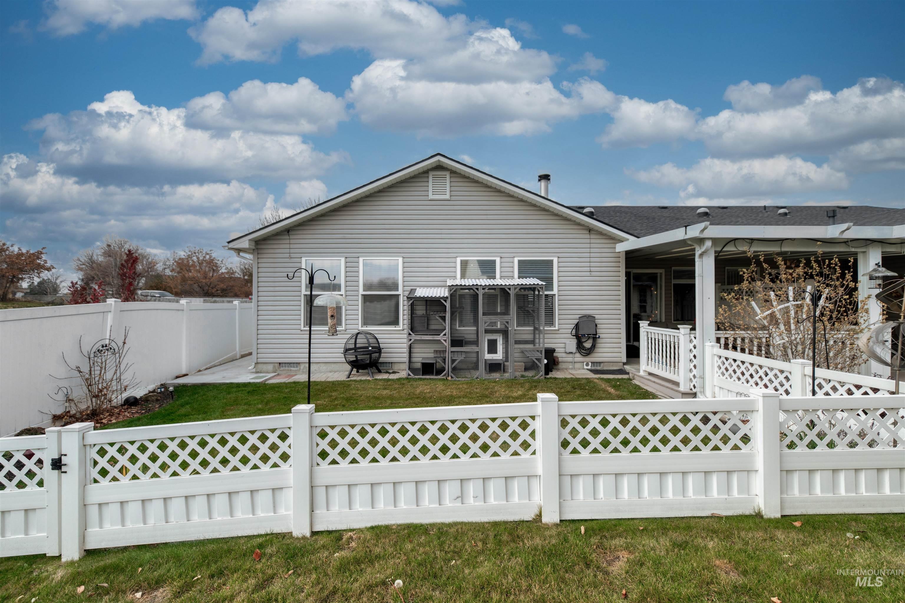 Rear view of property featuring a patio area and a fenced backyard