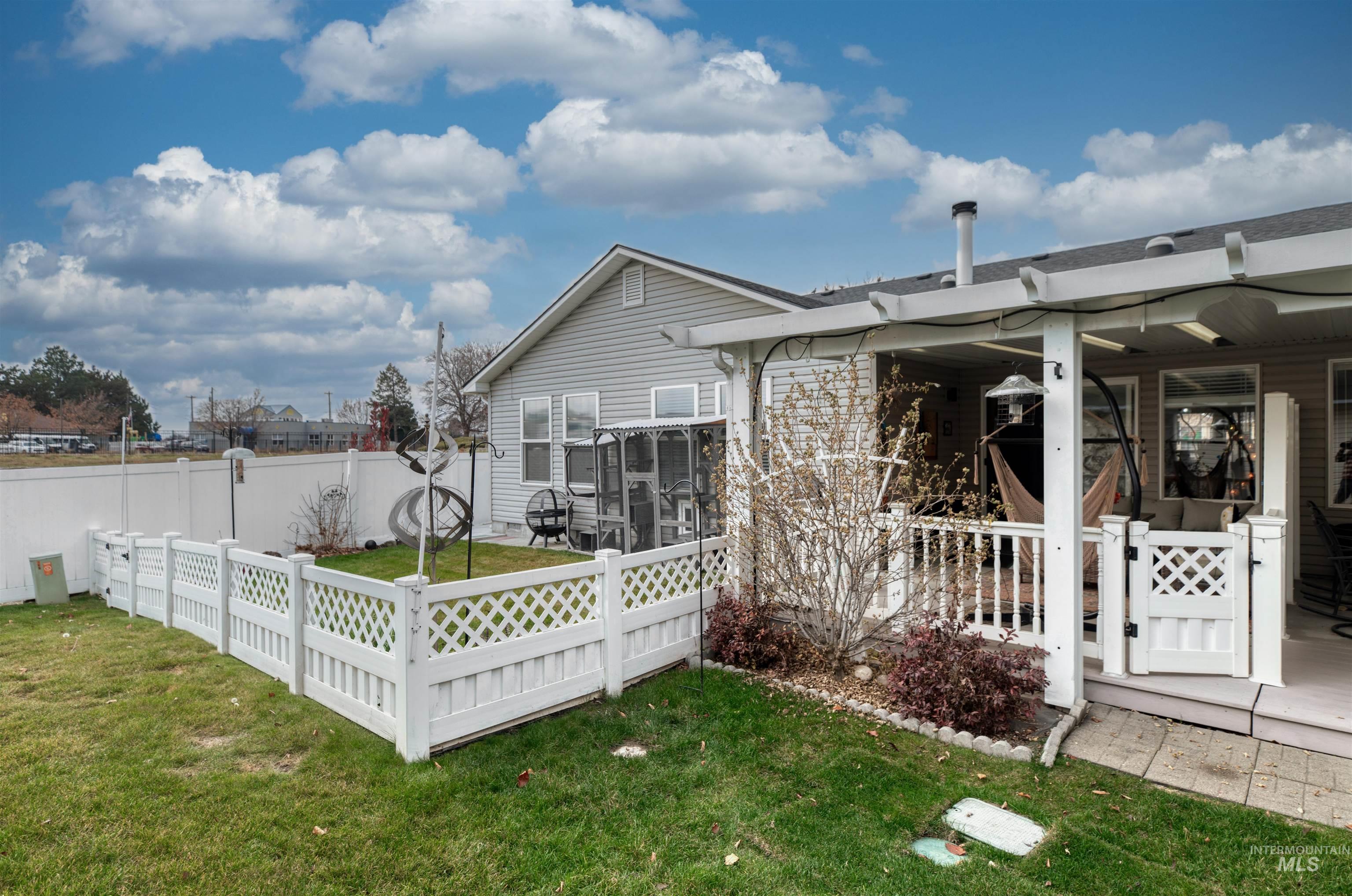 Rear view of property featuring a fenced backyard and a wooden deck