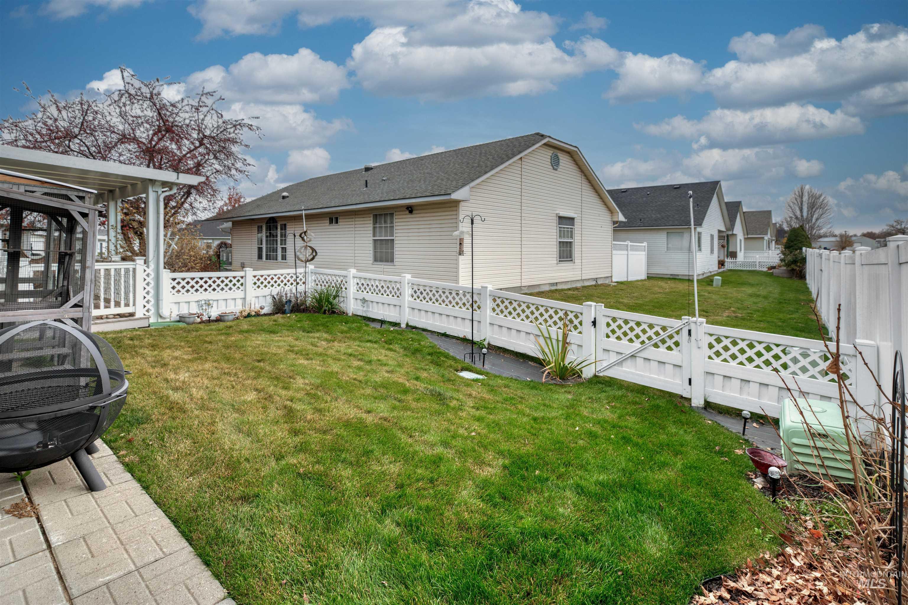 Back of house featuring a gate and a fenced backyard