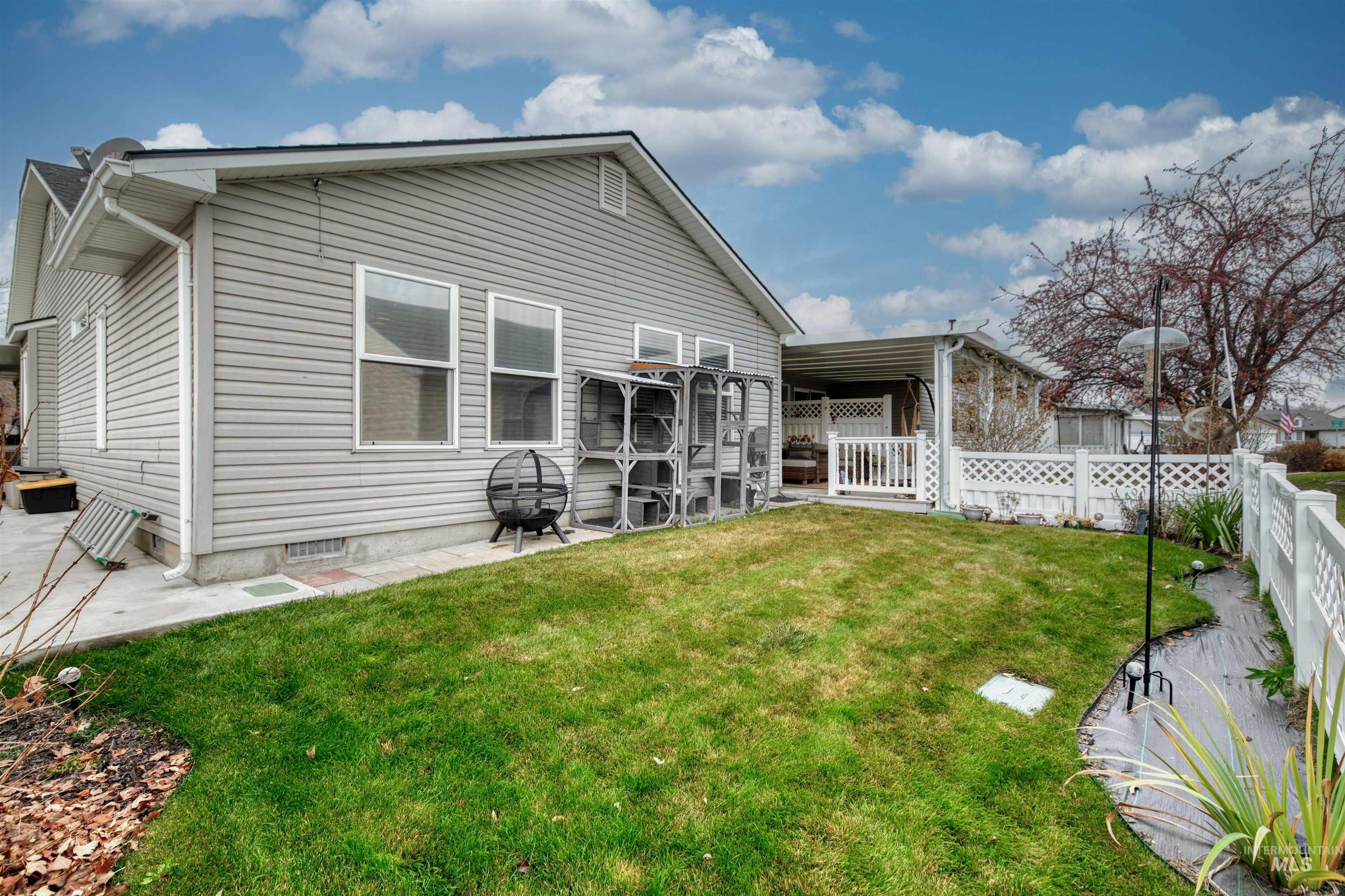 Back of house with a fenced backyard and a patio area