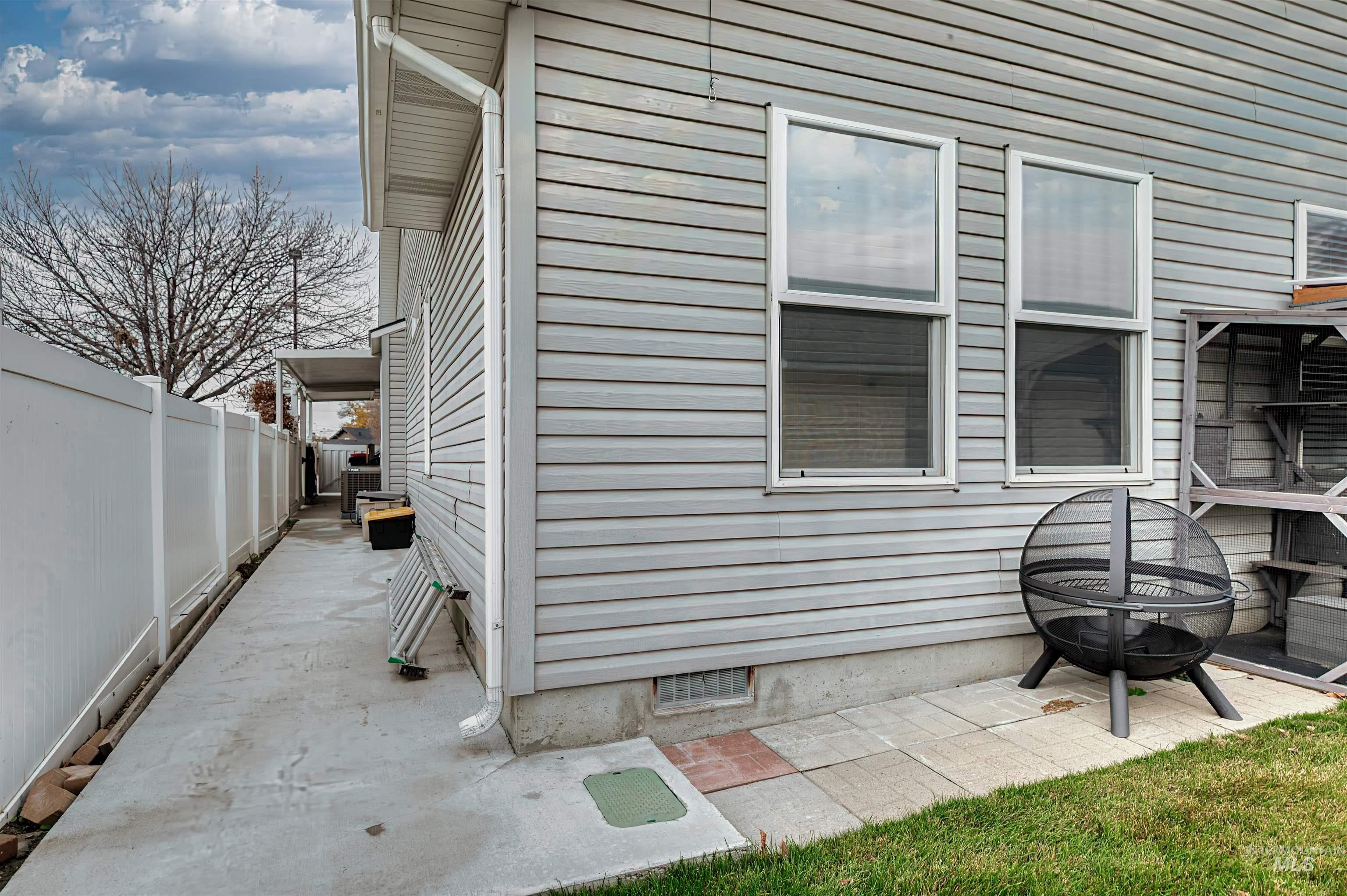 View of property exterior with an outdoor fire pit