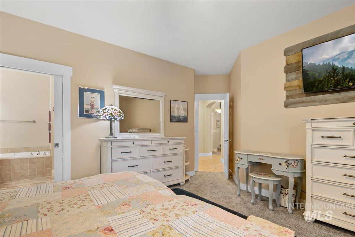 Bedroom with carpet and arched walkways