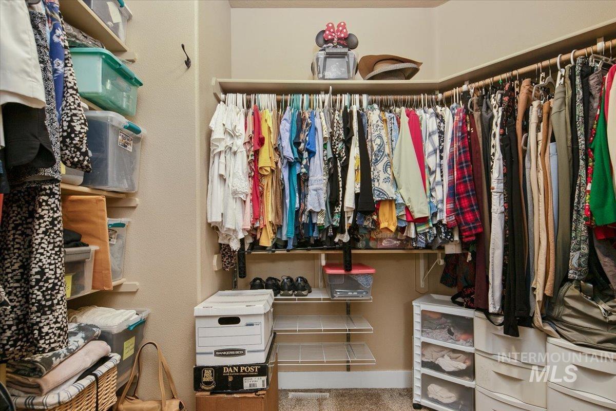 Spacious closet with light colored carpet