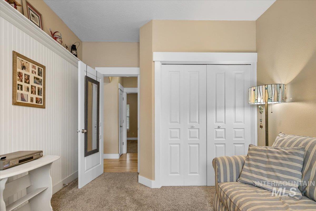 Sitting room with carpet and baseboards