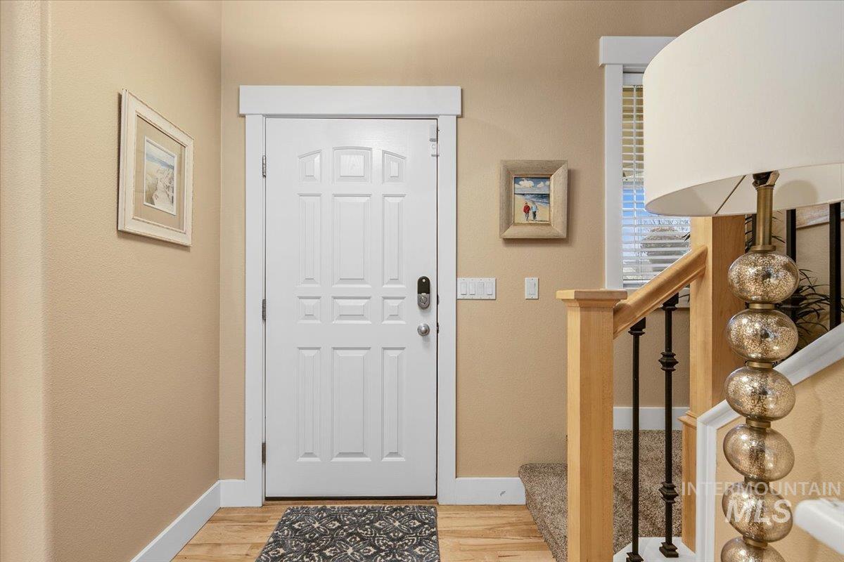 Entryway with light wood-style floors and stairway