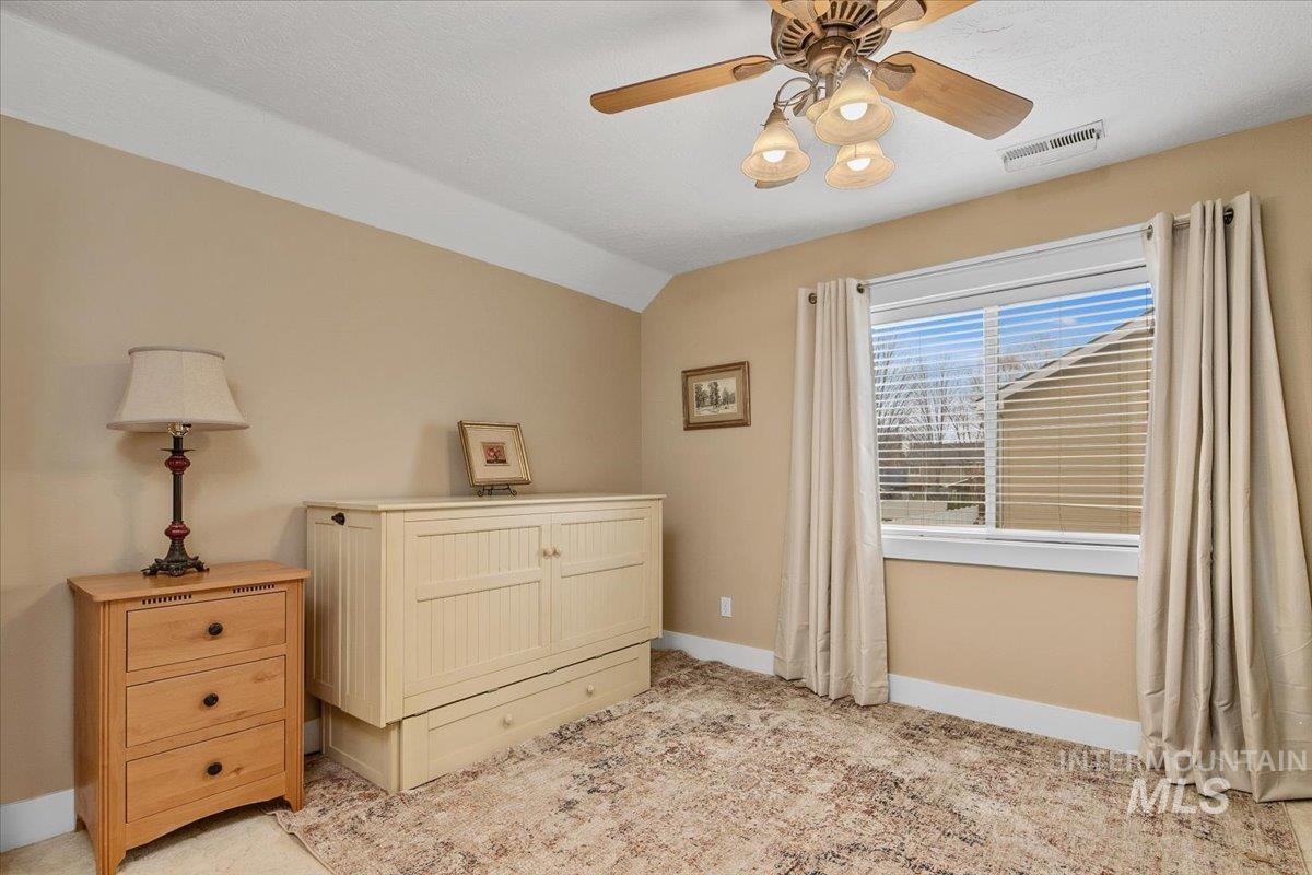 Bedroom with lofted ceiling and a ceiling fan