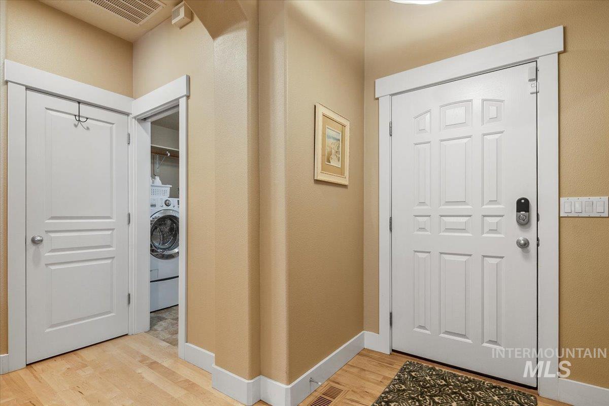 Foyer featuring light wood-style flooring and washer / clothes dryer
