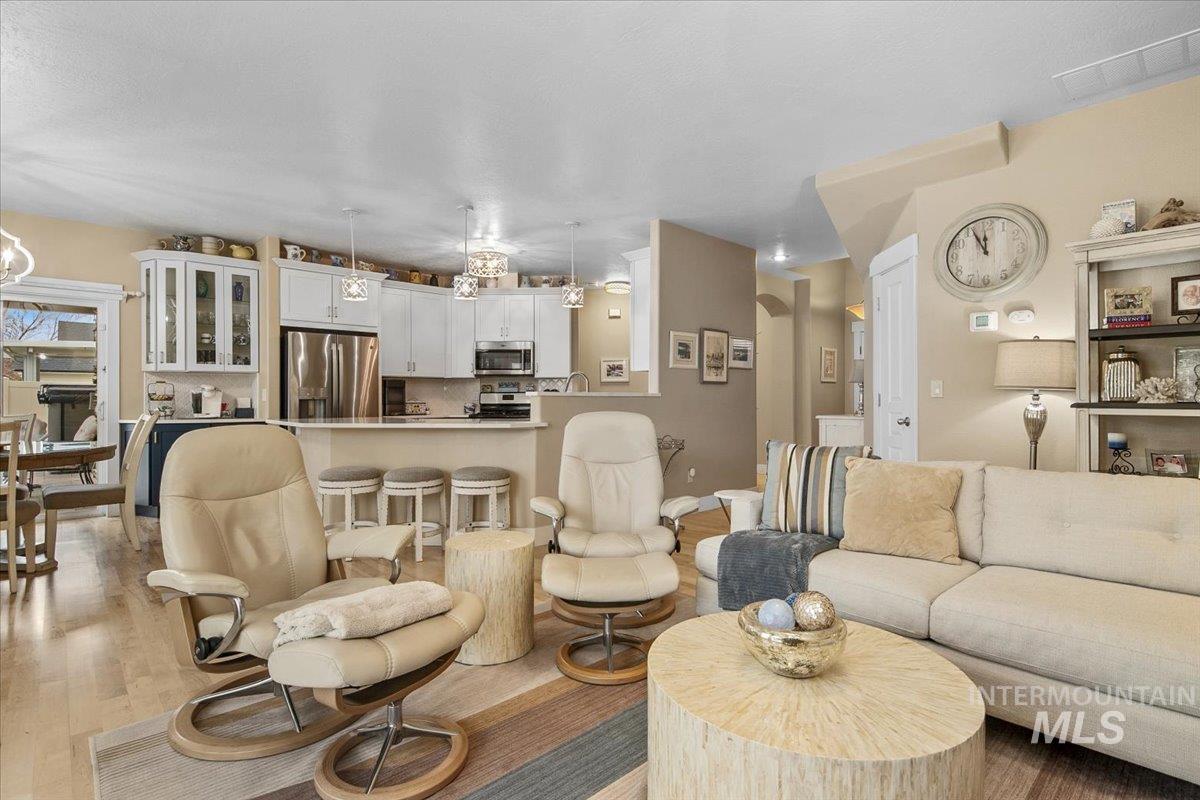 Living room with a chandelier and light wood-type flooring