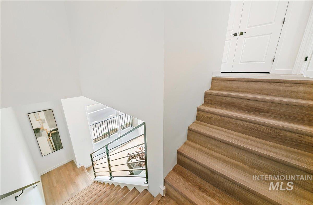 Stairway featuring wood finished floors