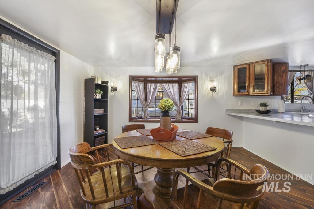 Dining room with dark wood-type flooring