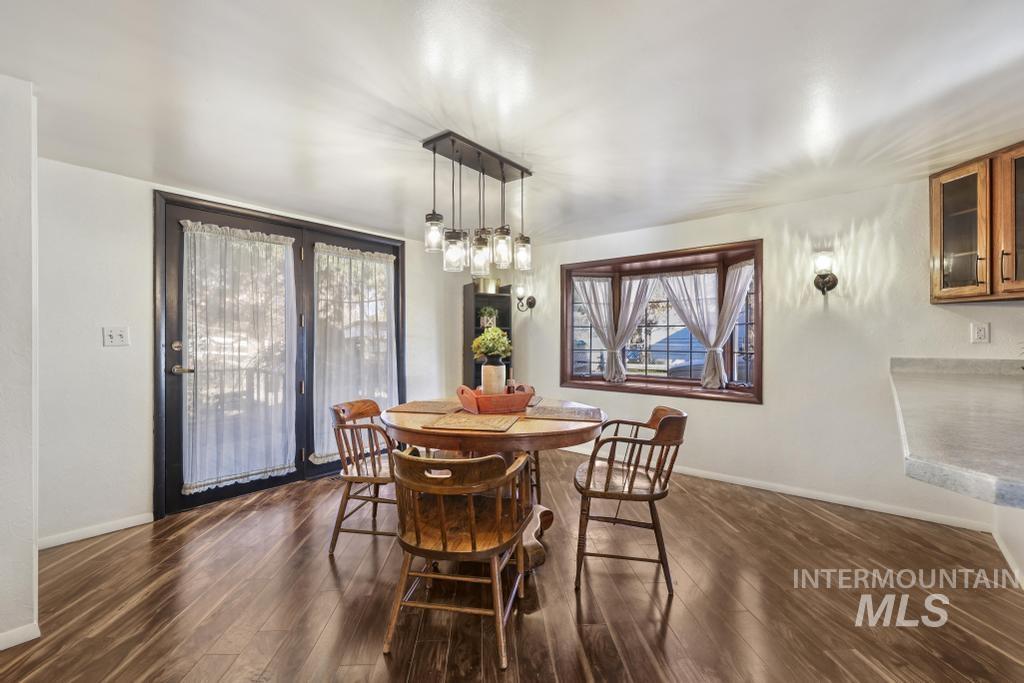 Dining room featuring dark wood-style flooring