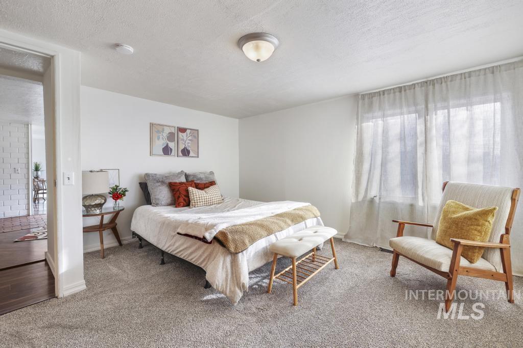 Carpeted bedroom featuring a textured ceiling