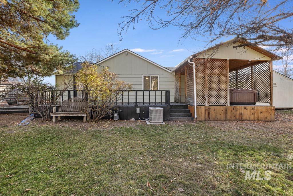 Rear view of property with a wooden deck and a yard