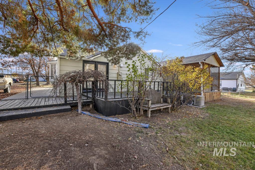 Rear view of property featuring a deck and a gate