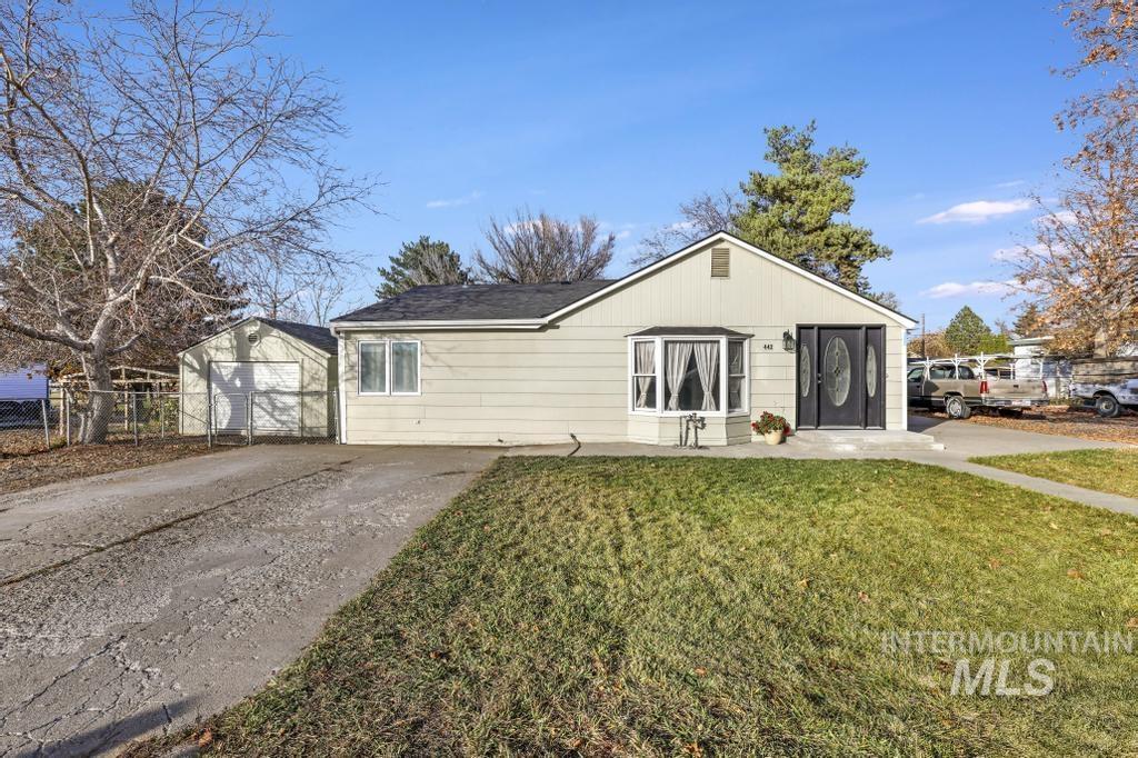 View of front of home with an outbuilding and driveway