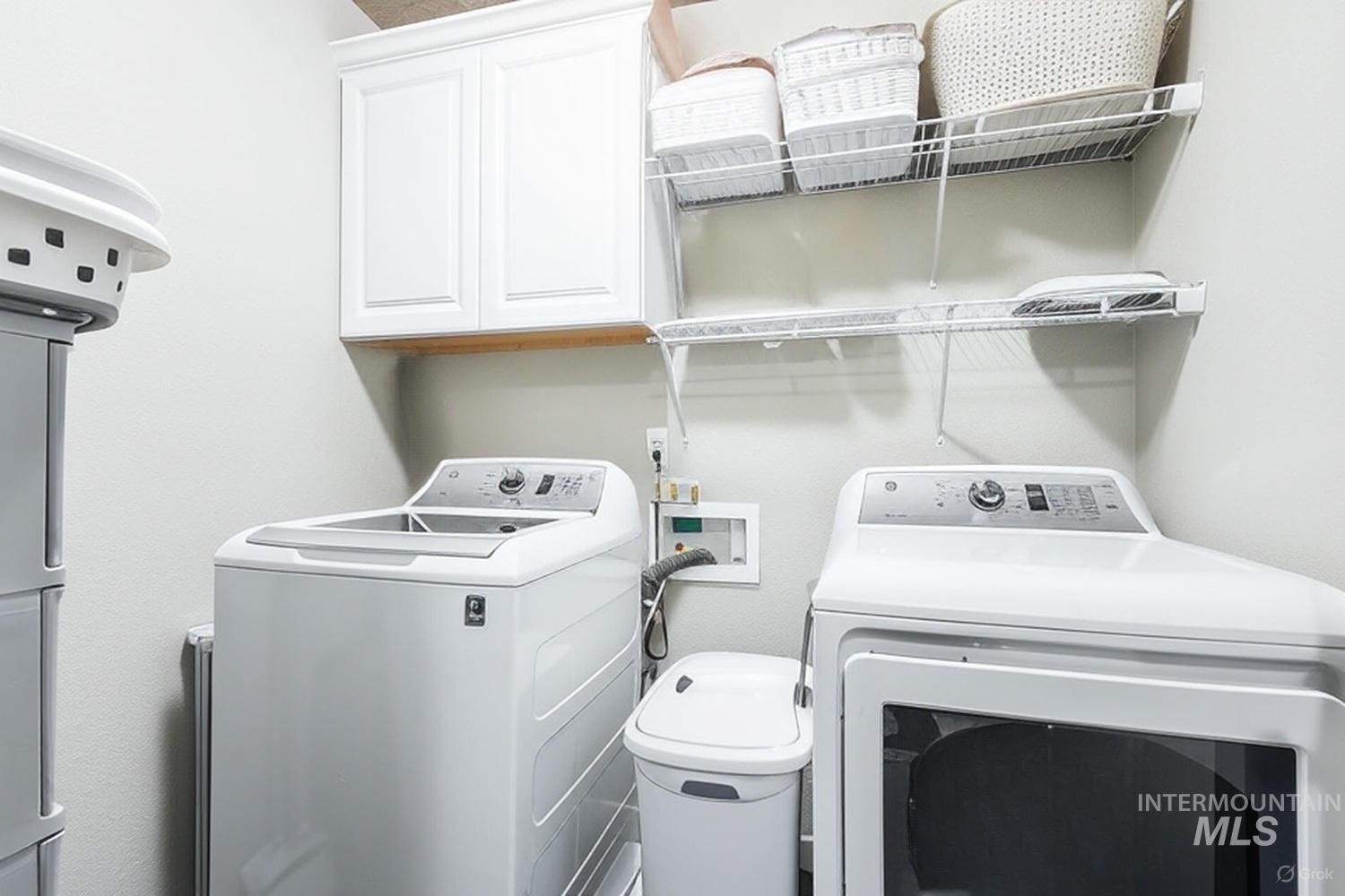 Laundry room featuring washer and dryer and cabinet space