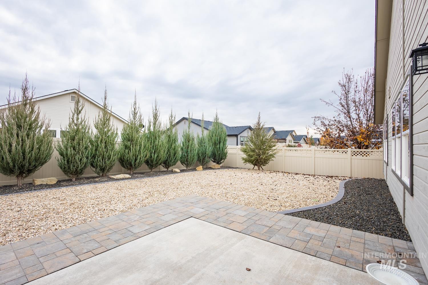 Fenced backyard with a patio