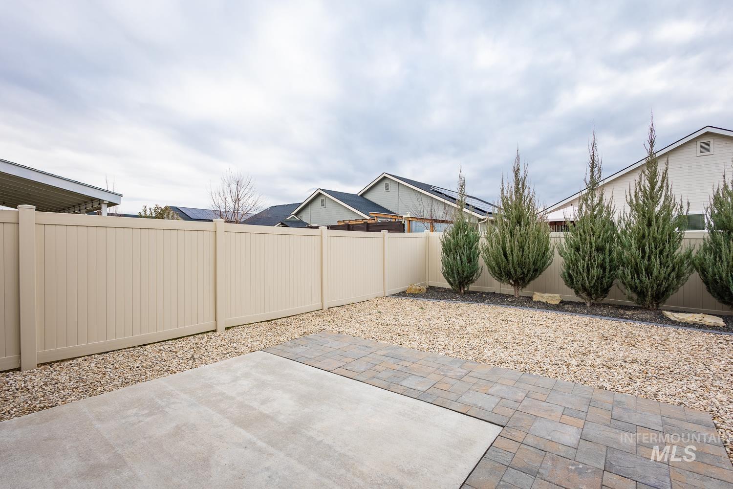 Fenced backyard with a patio area