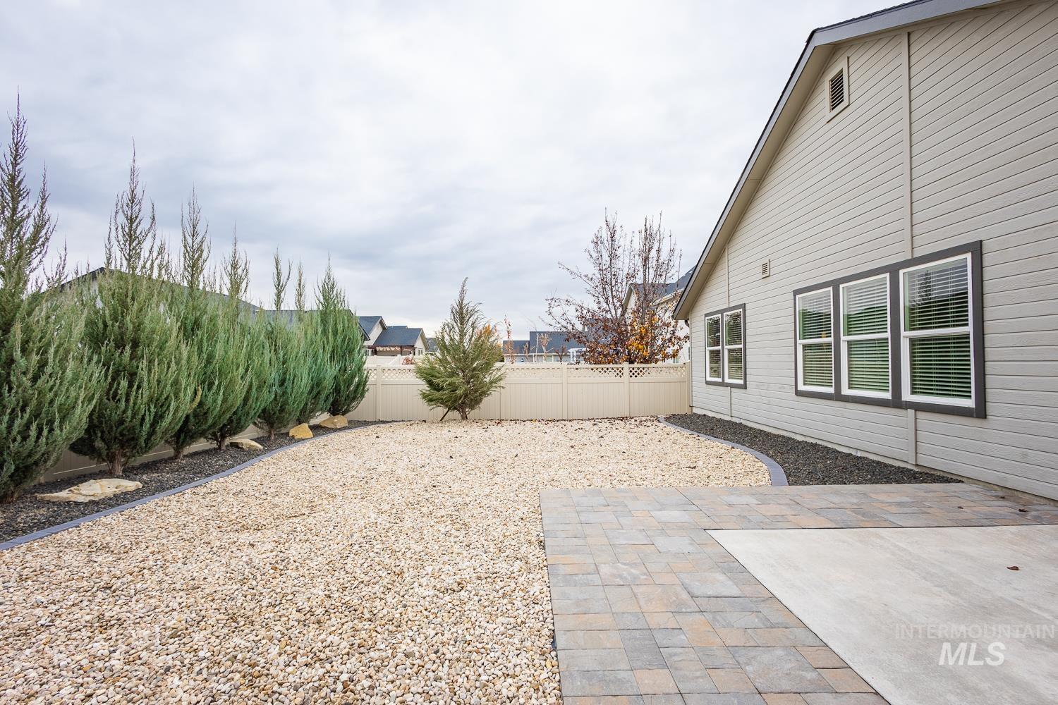 Fenced backyard featuring a patio