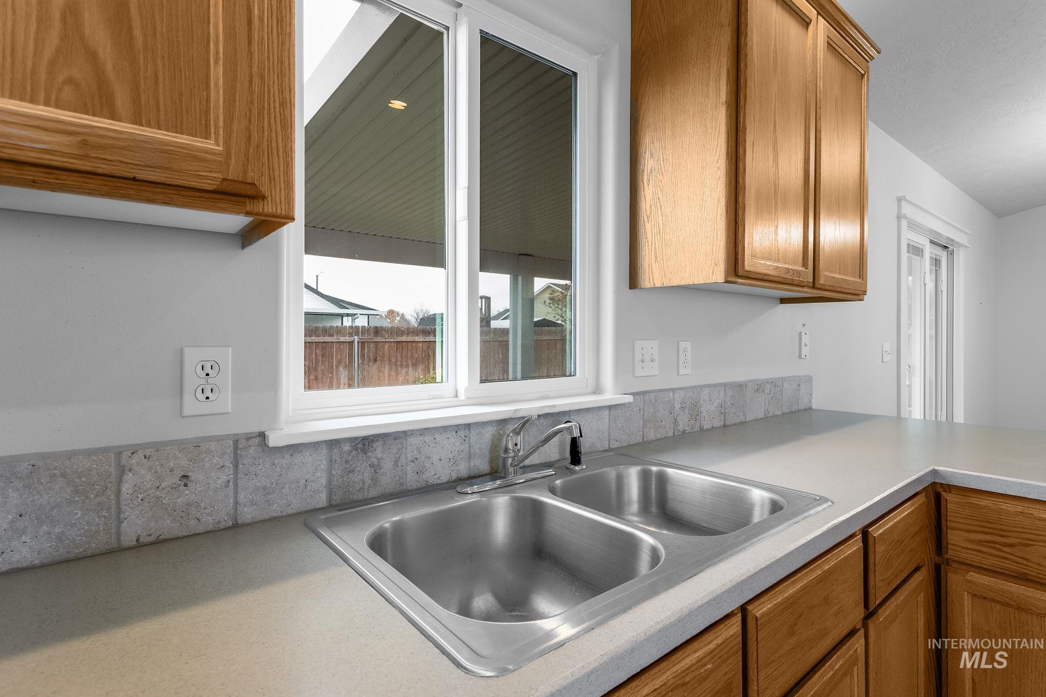 Kitchen featuring brown cabinets and light countertops