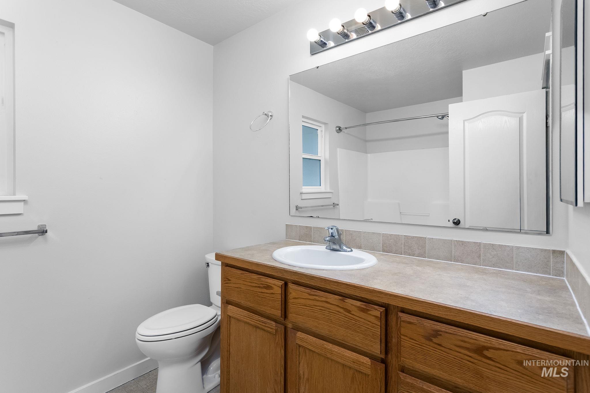 Bathroom with vanity and a shower