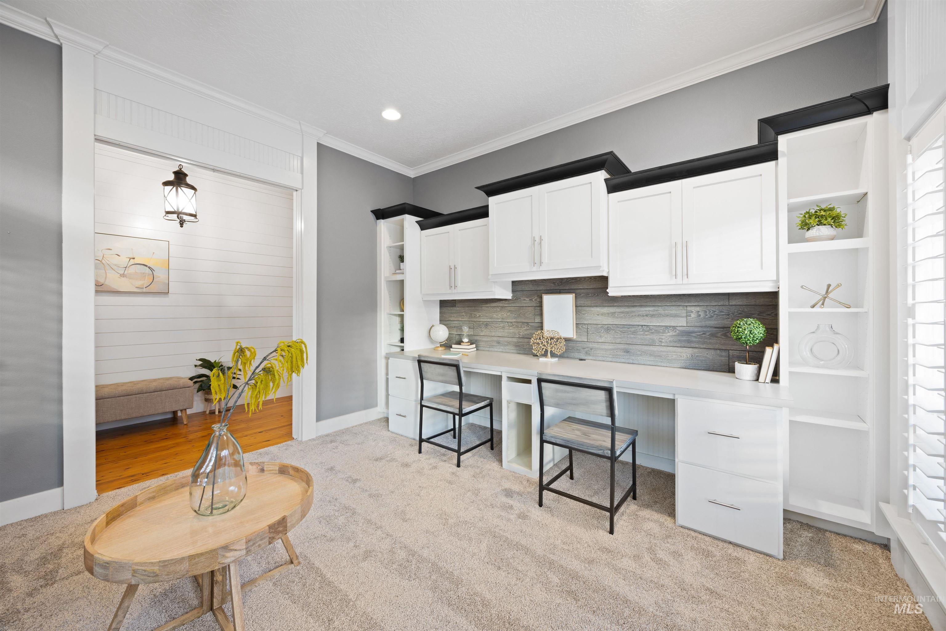 white cabinetry, light carpet, open shelves, and crown molding