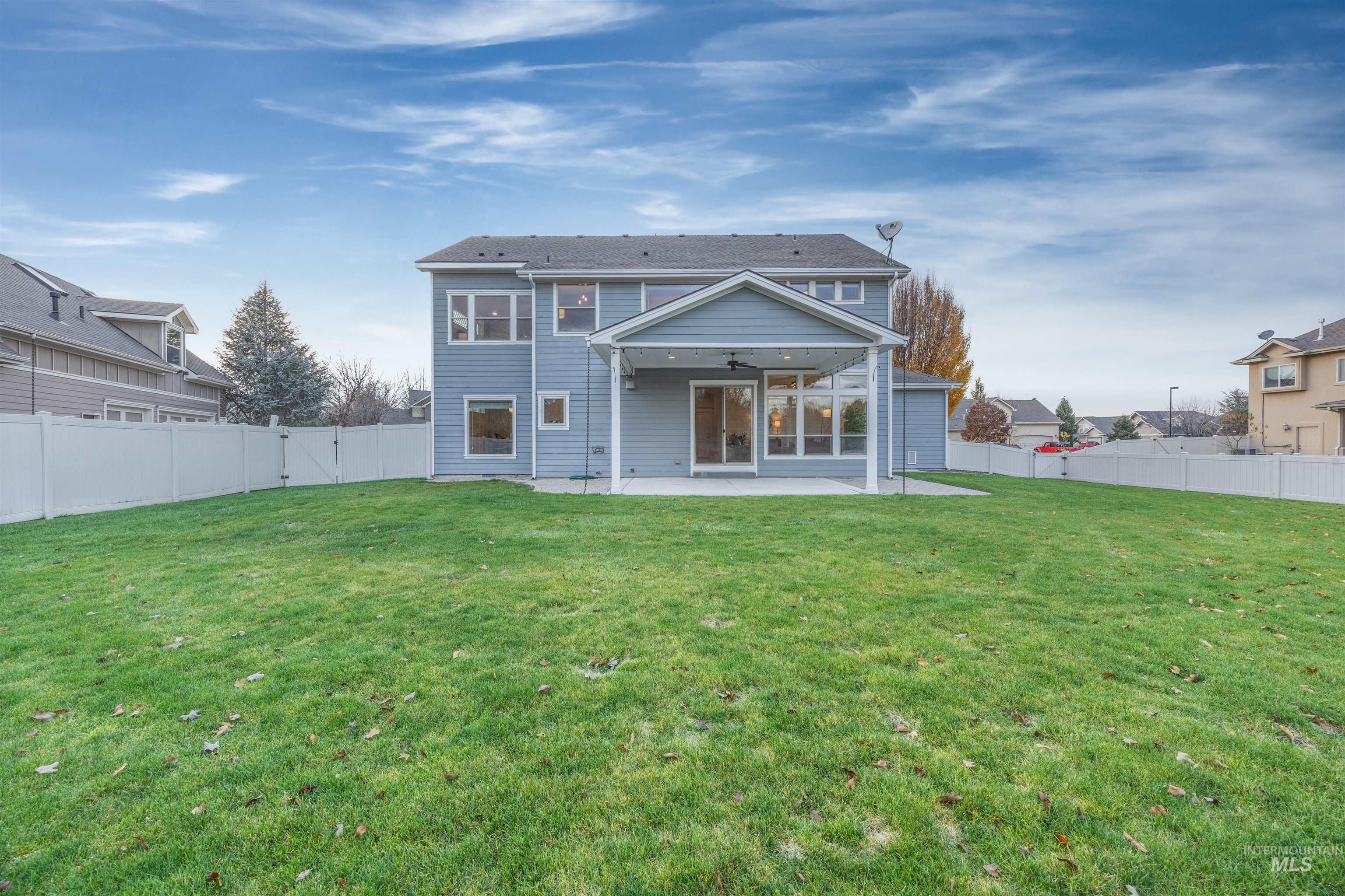 Back of property with ceiling fan, a patio area, and a fenced backyard