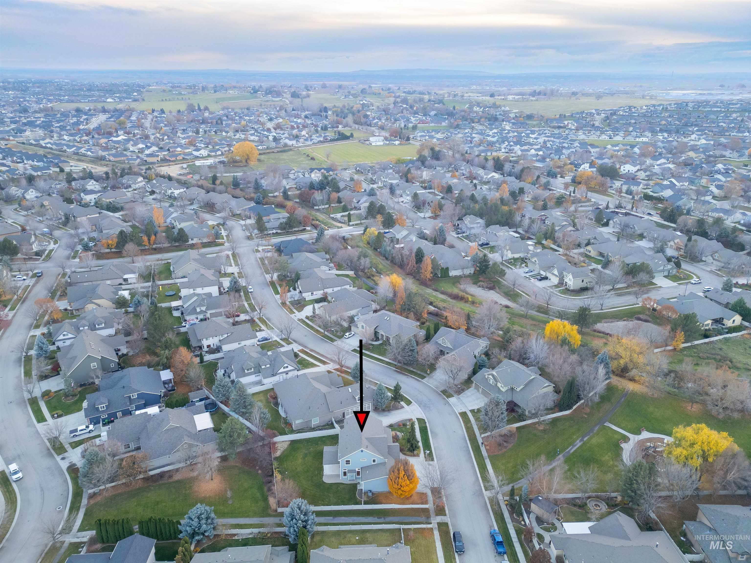 Aerial view of property's location with nearby suburban area