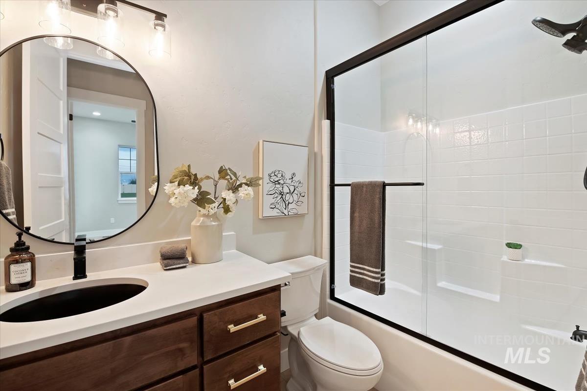 Bathroom with vanity and shower / bath combination with glass door