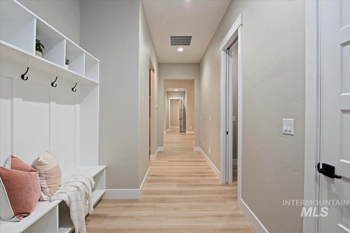 Mudroom featuring light wood finished floors and recessed lighting